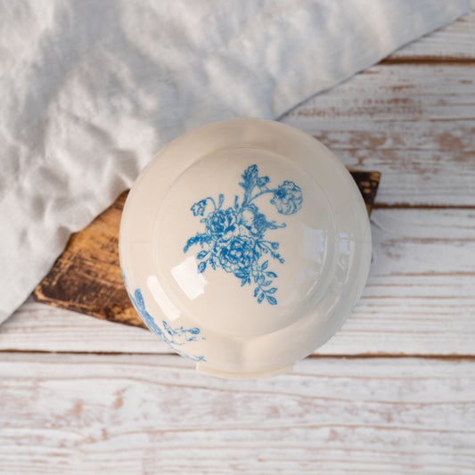 Top-down view of hand-painted ceramic lid with blue floral toile seamless pattern for small heart urn