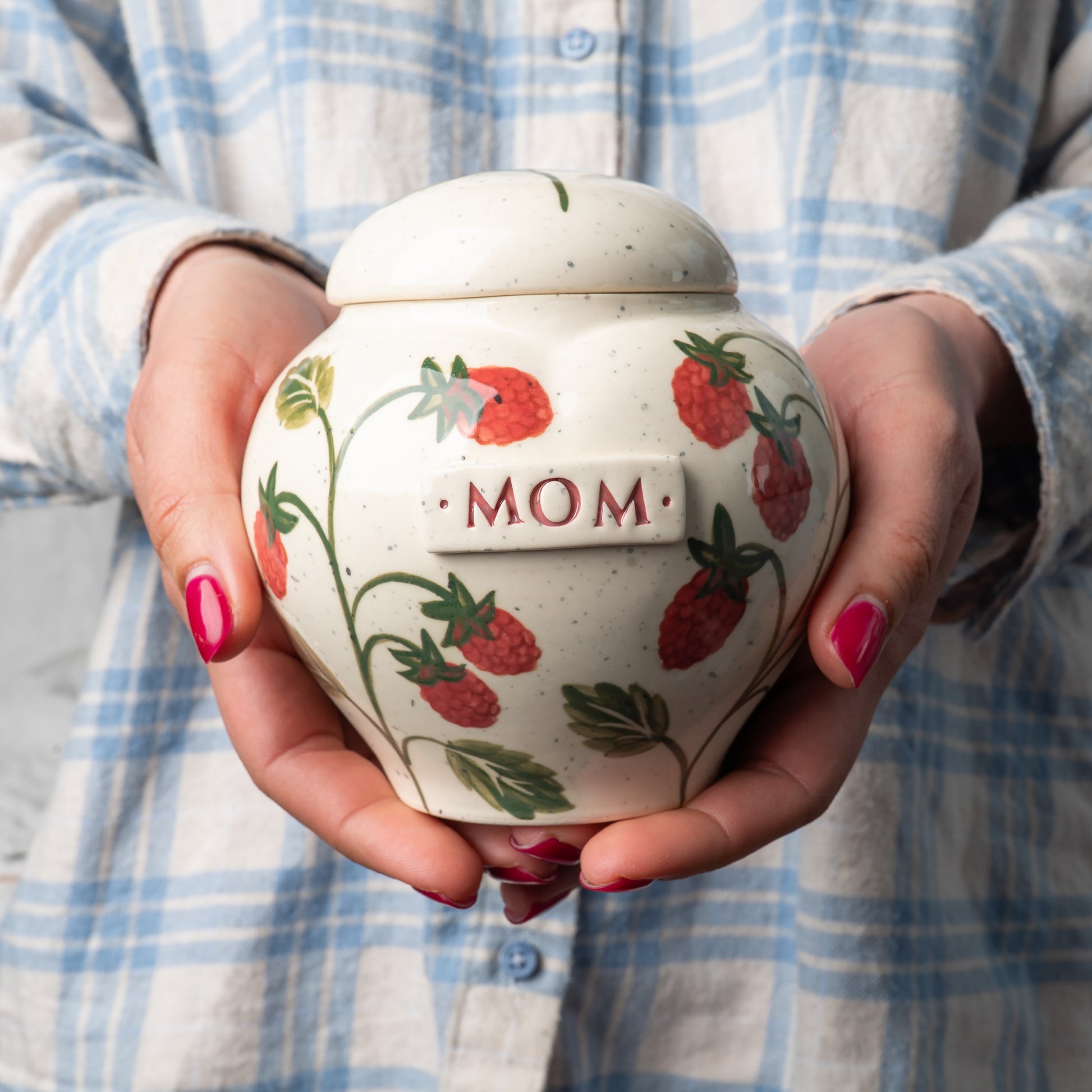 holding Raspberry heart urn in hands