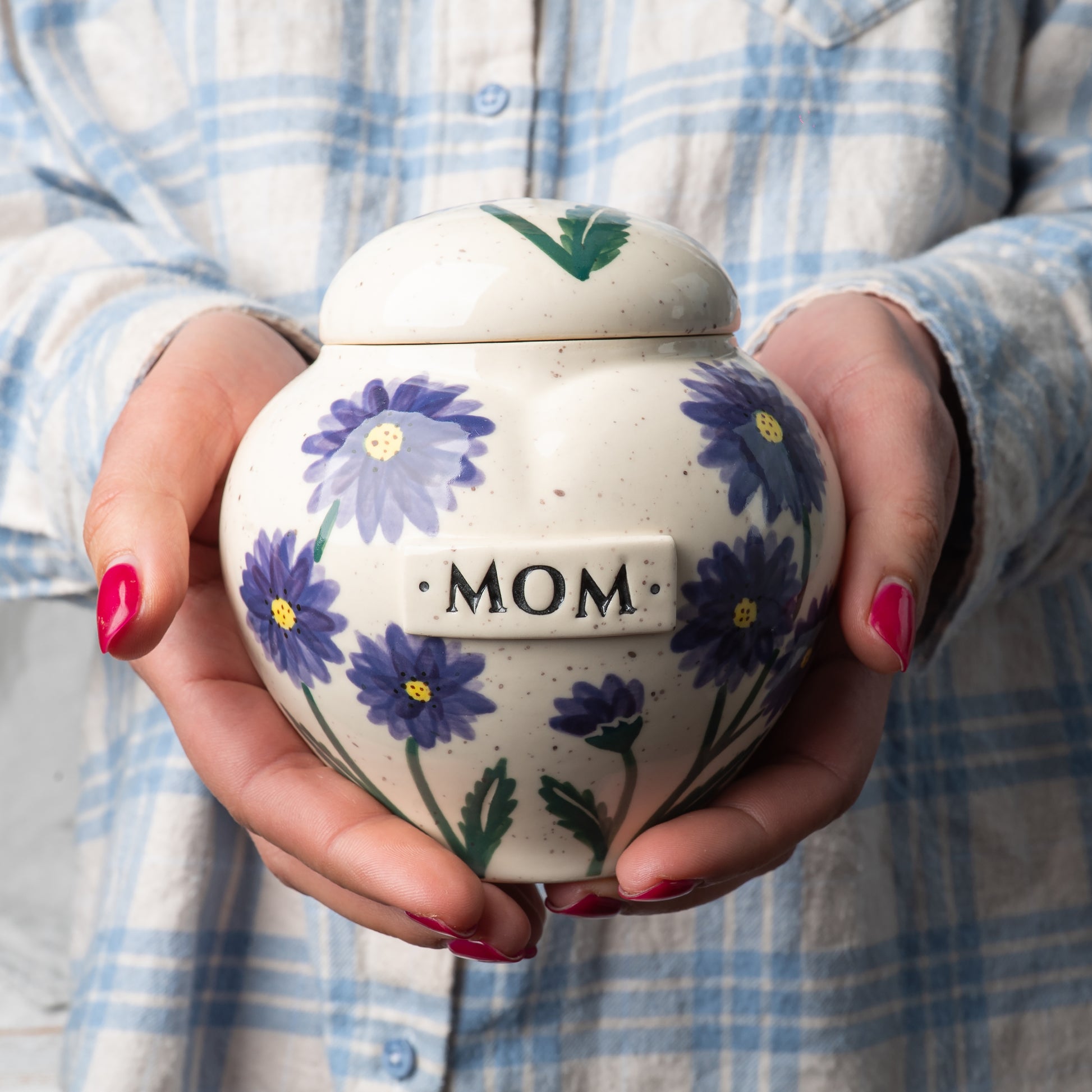 Small custom heart ceramic aster birth flower keepsake urn held gently in hands for scale