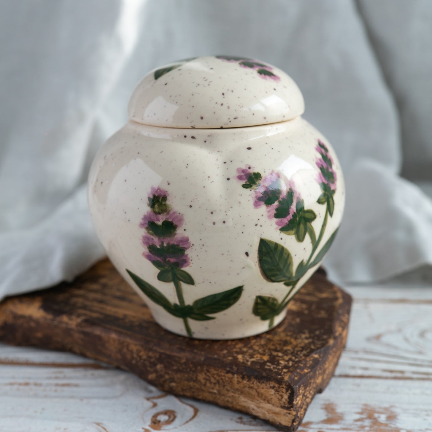 Hand-painted green basil leaf ceramic heart-shaped keepsake urn for human or pet ashes back side view