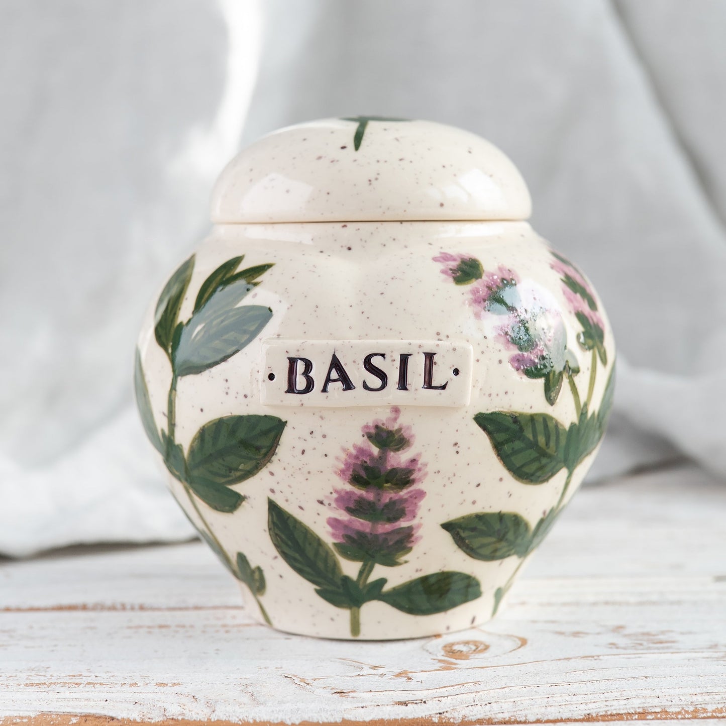 Hand-painted green basil leaf ceramic heart-shaped keepsake urn for human or pet ashes.