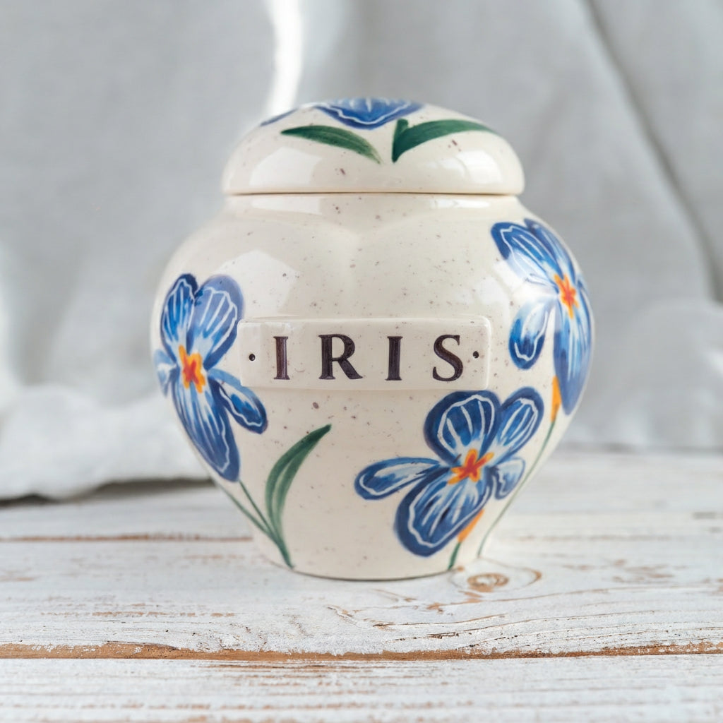 Side view of hand-painted heart ceramic parent memorial urn featuring blue iris floral artwork