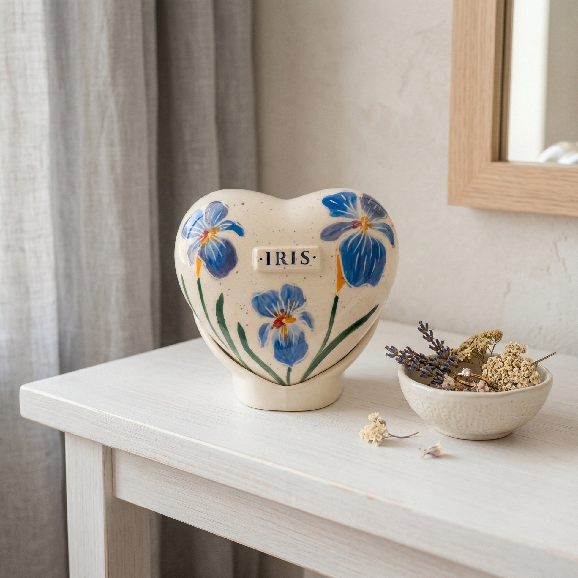 A peaceful home memorial display with a blue iris heart urn on a table