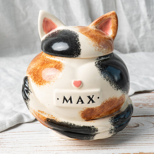 Calico cat heart-shaped ceramic urn for ashes with sculpted cat ears and tail front view