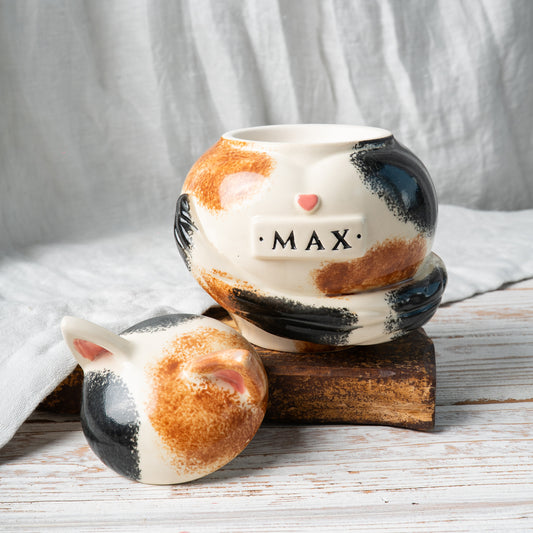 Custom calico cat ceramic urn with cat ears shown open revealing inner chamber for ashes