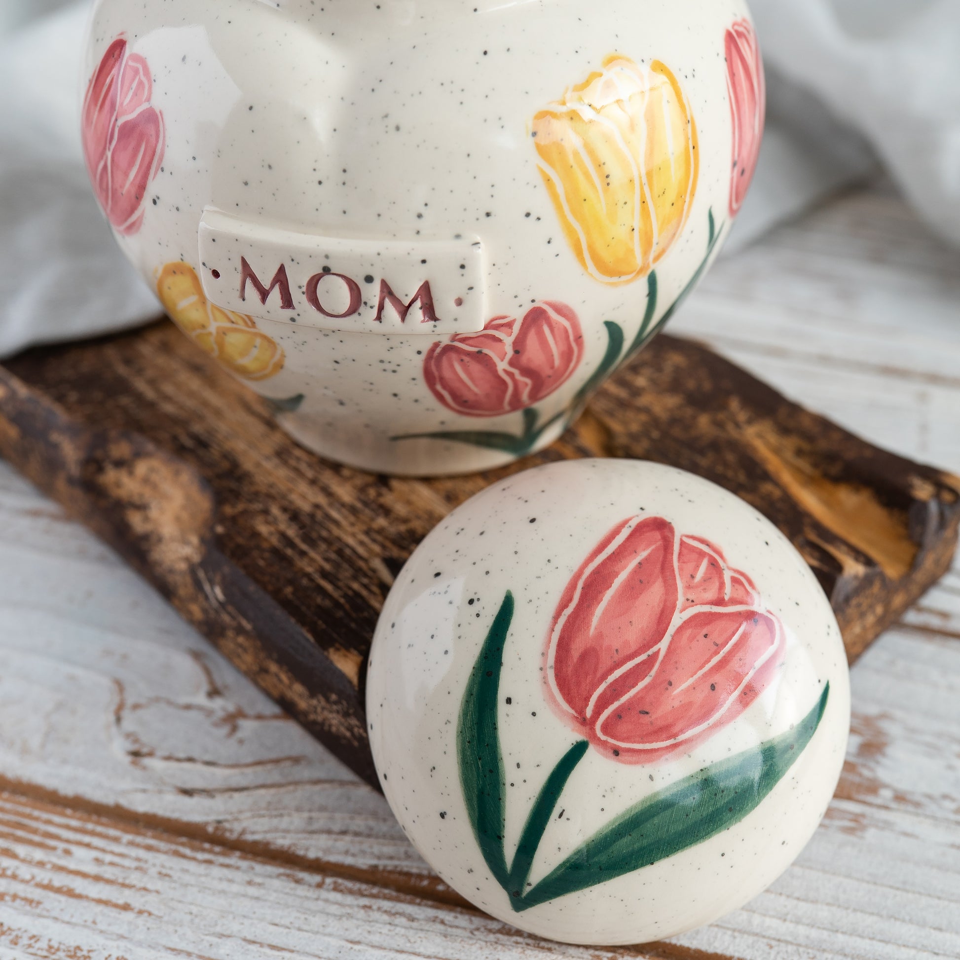 Close-up showing the lid of the tulip-patterned heart-shaped keepsake urn for Mom or Dad