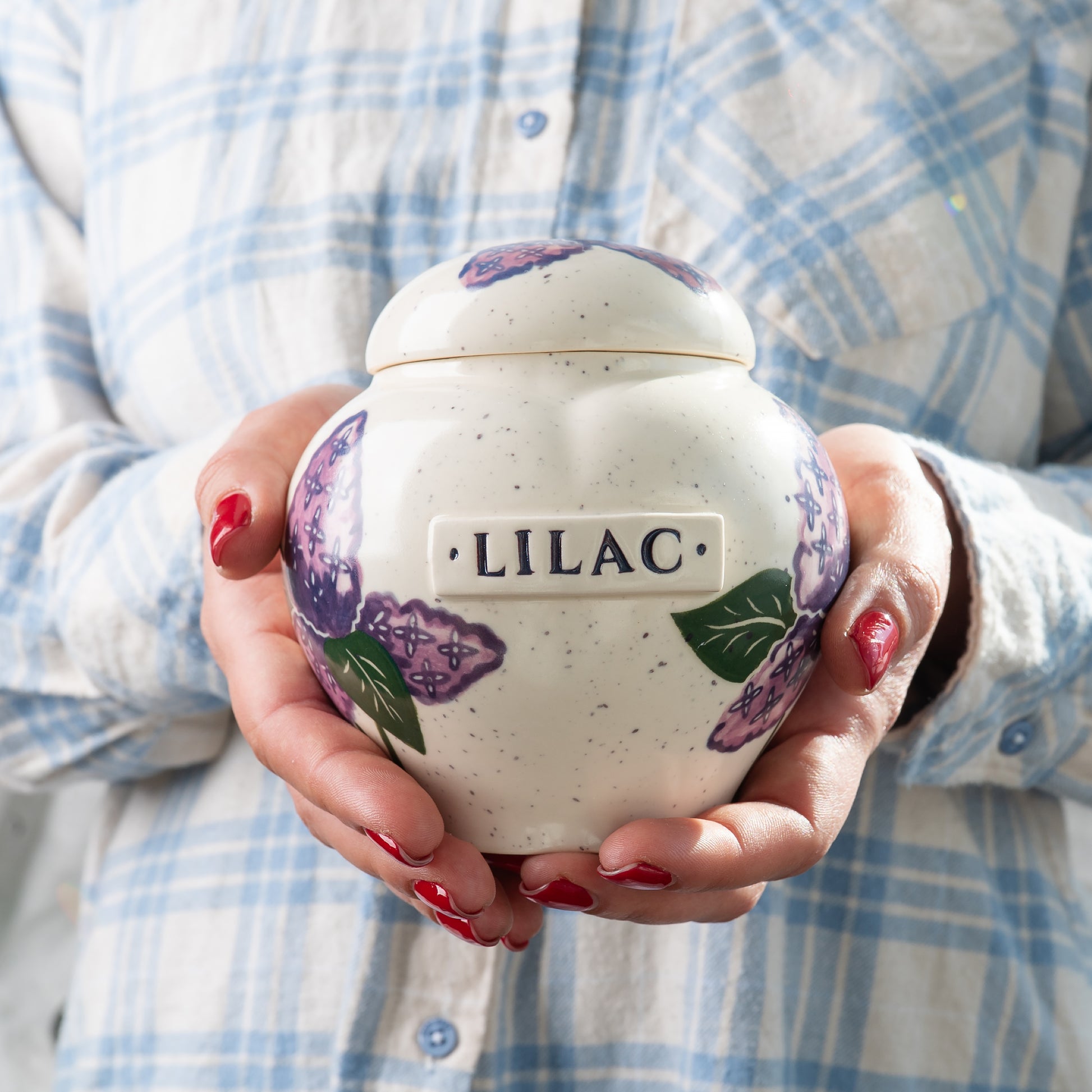 Holding a small lilac heart keepsake urn for scale