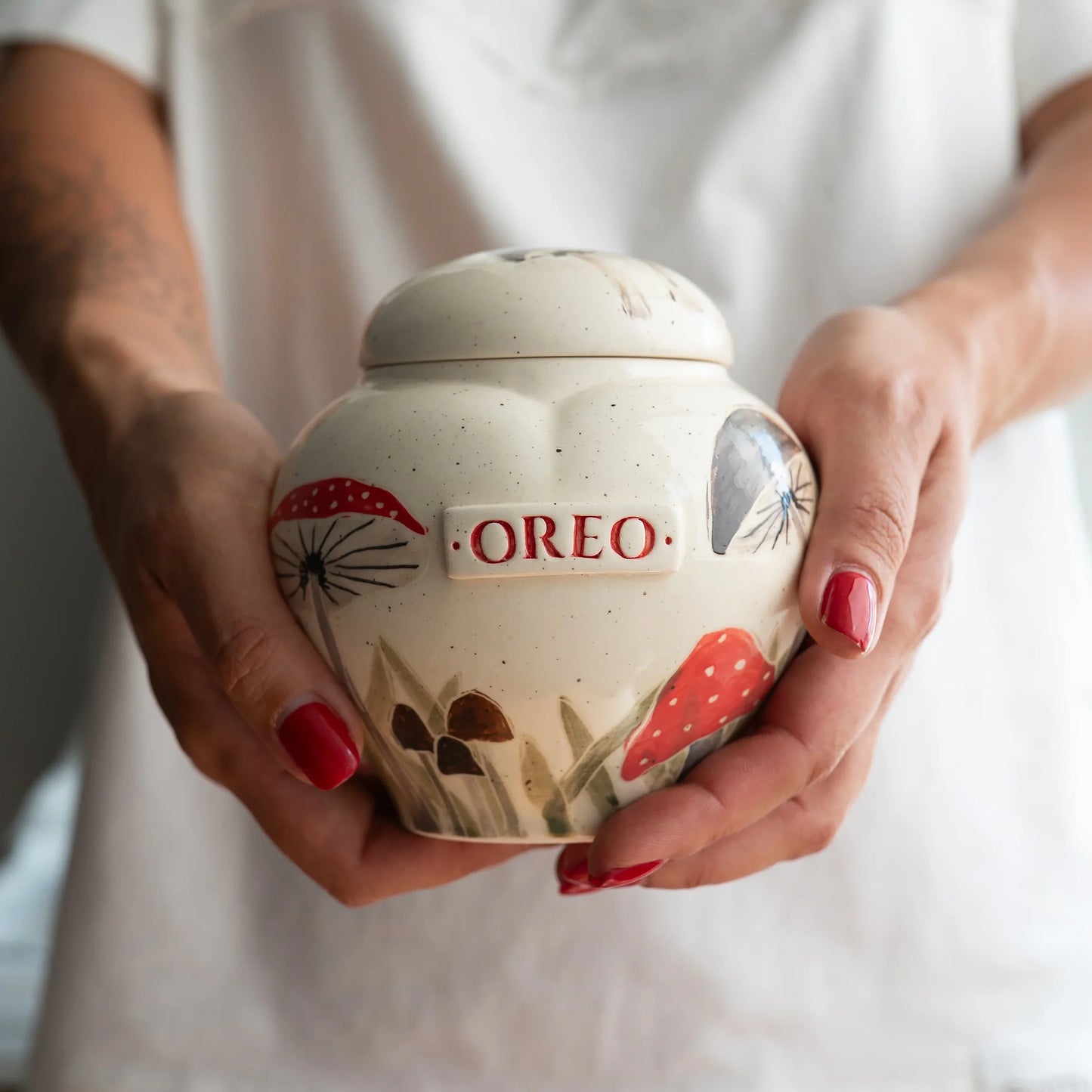 Holding a small mushrooms heart keepsake urn for scale