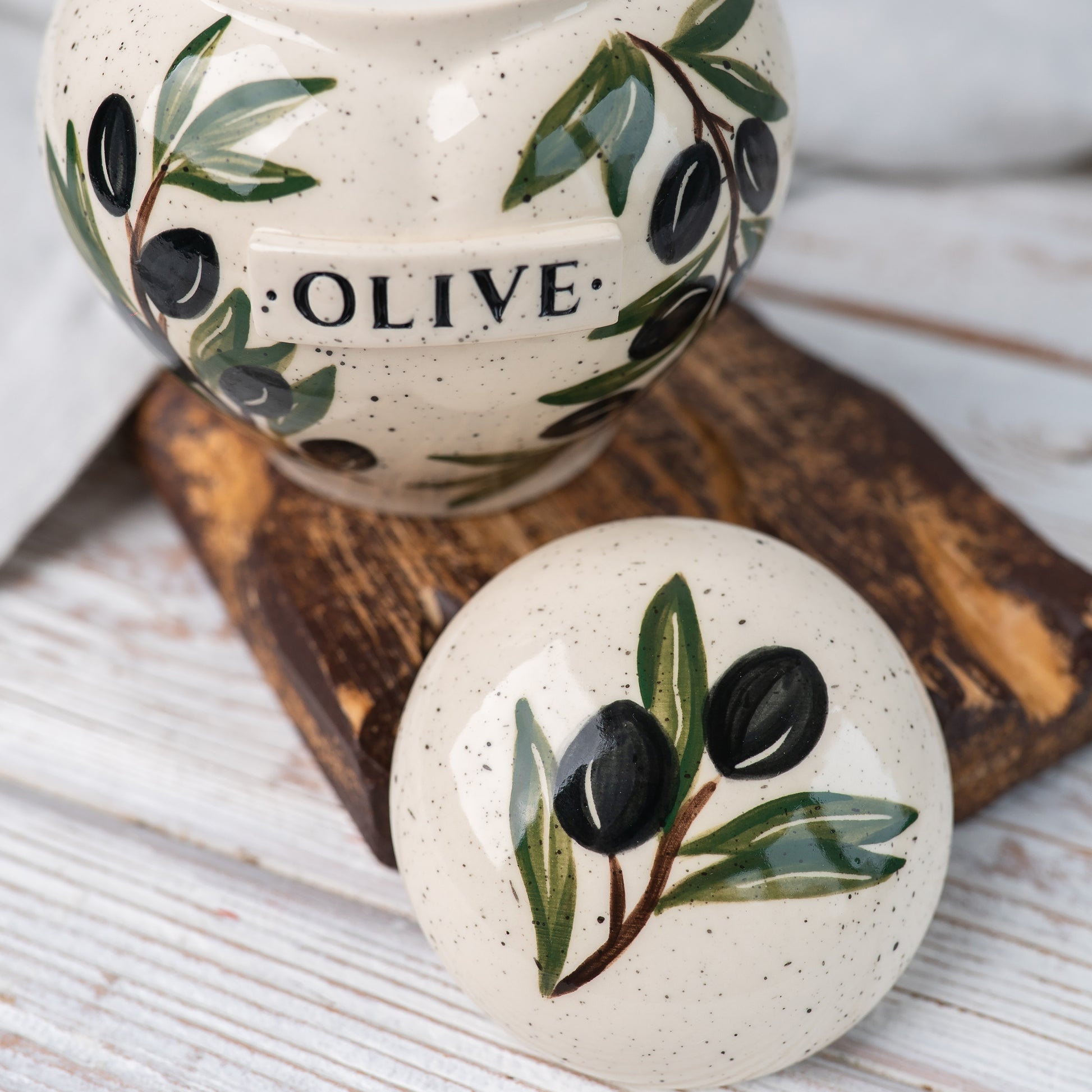 Close-up of open olive branch ceramic heart urn lid by Mira Ceramics.