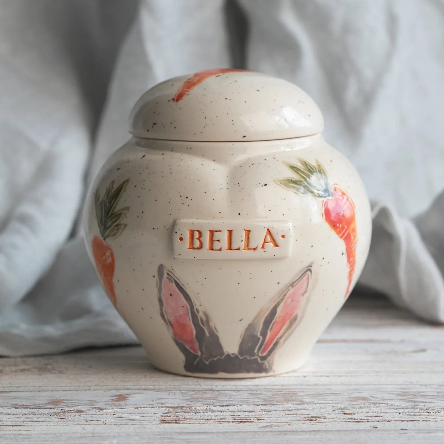 Hand-painted rabbit ears and carrots ceramic heart urn by Mira Ceramics.