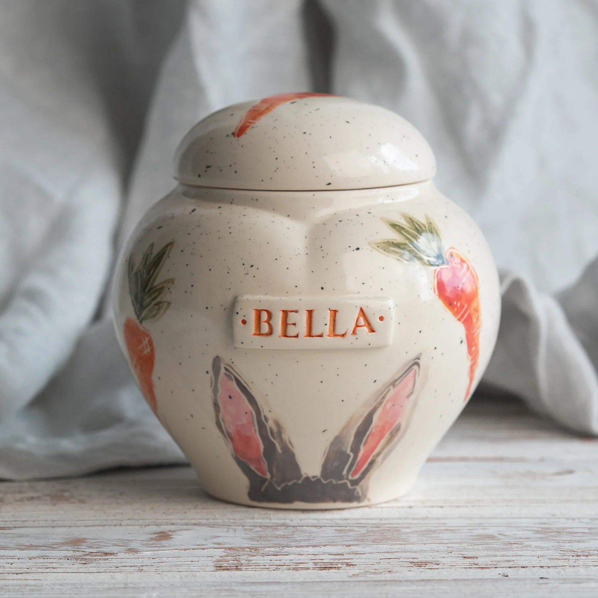 Hand-painted rabbit ears and carrots ceramic heart urn by Mira Ceramics.