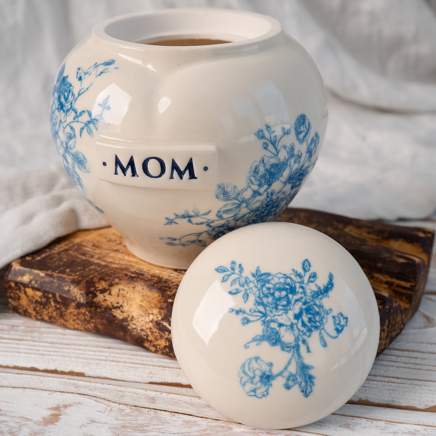 Blue and white floral toile heart ceramic urn shown open revealing inner chamber for ashes