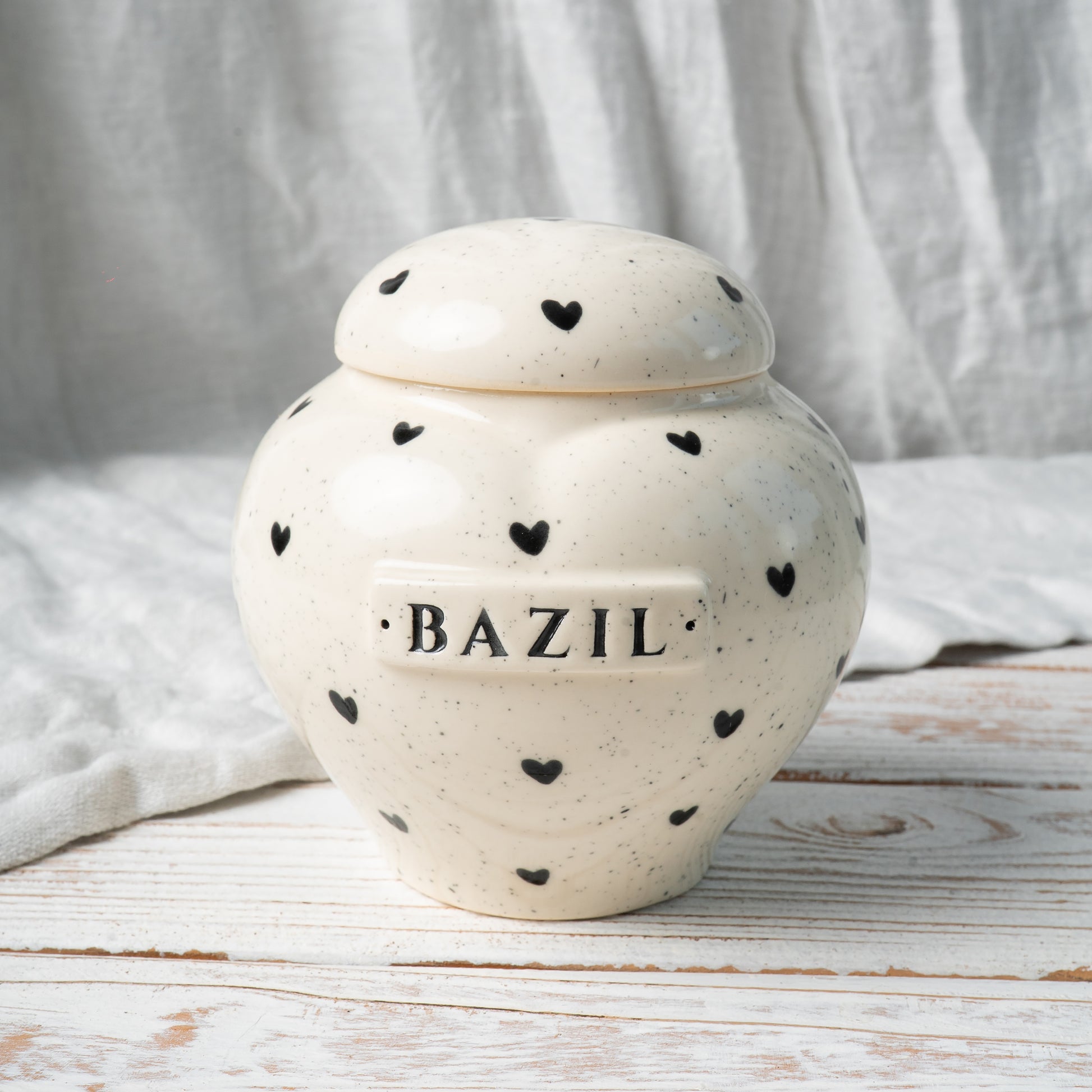 Front view of hand-painted heart-shaped ceramic memorial urn featuring heart pattern details