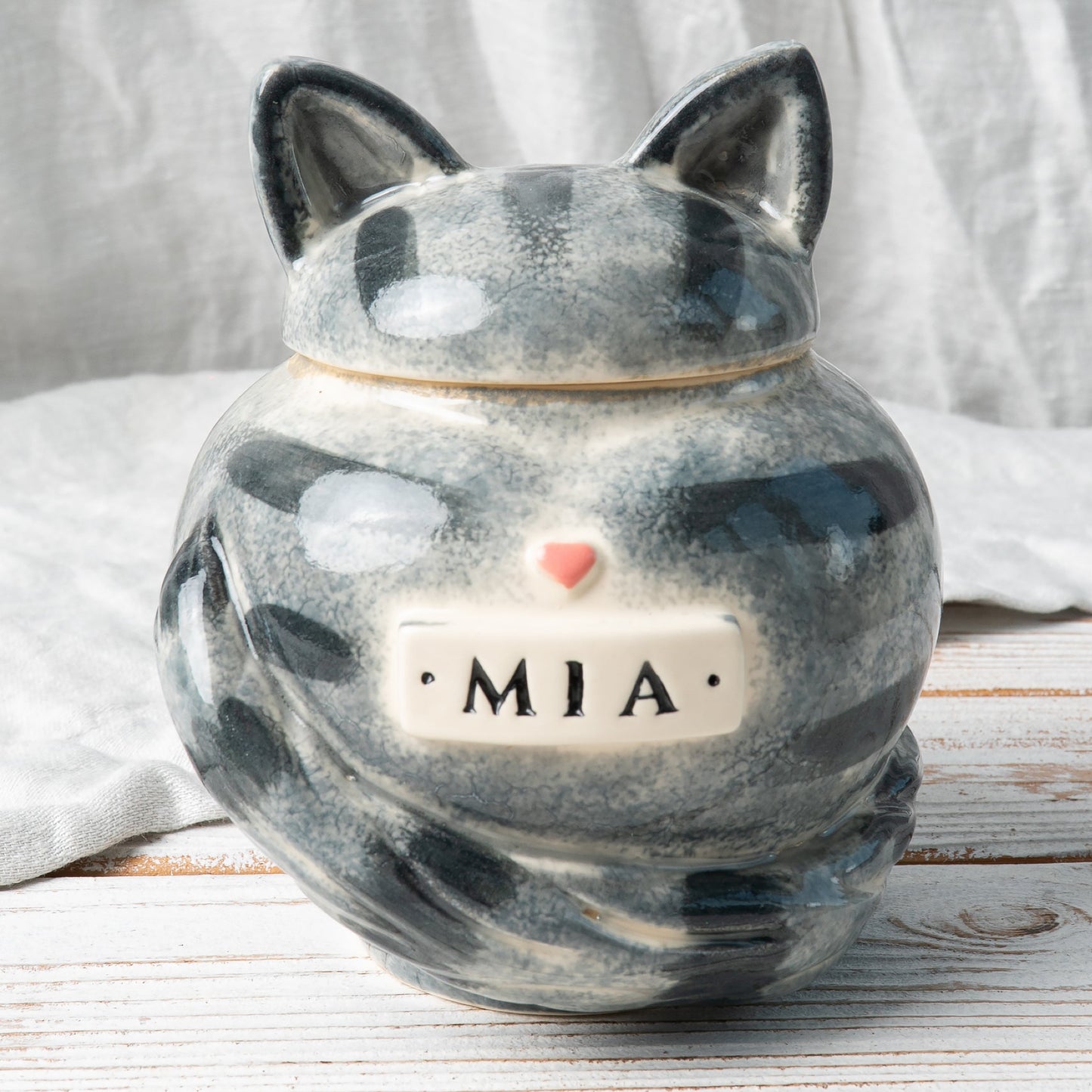 Gray tabby stripes cat heart-shaped ceramic urn for ashes with sculpted cat ears and tail front view