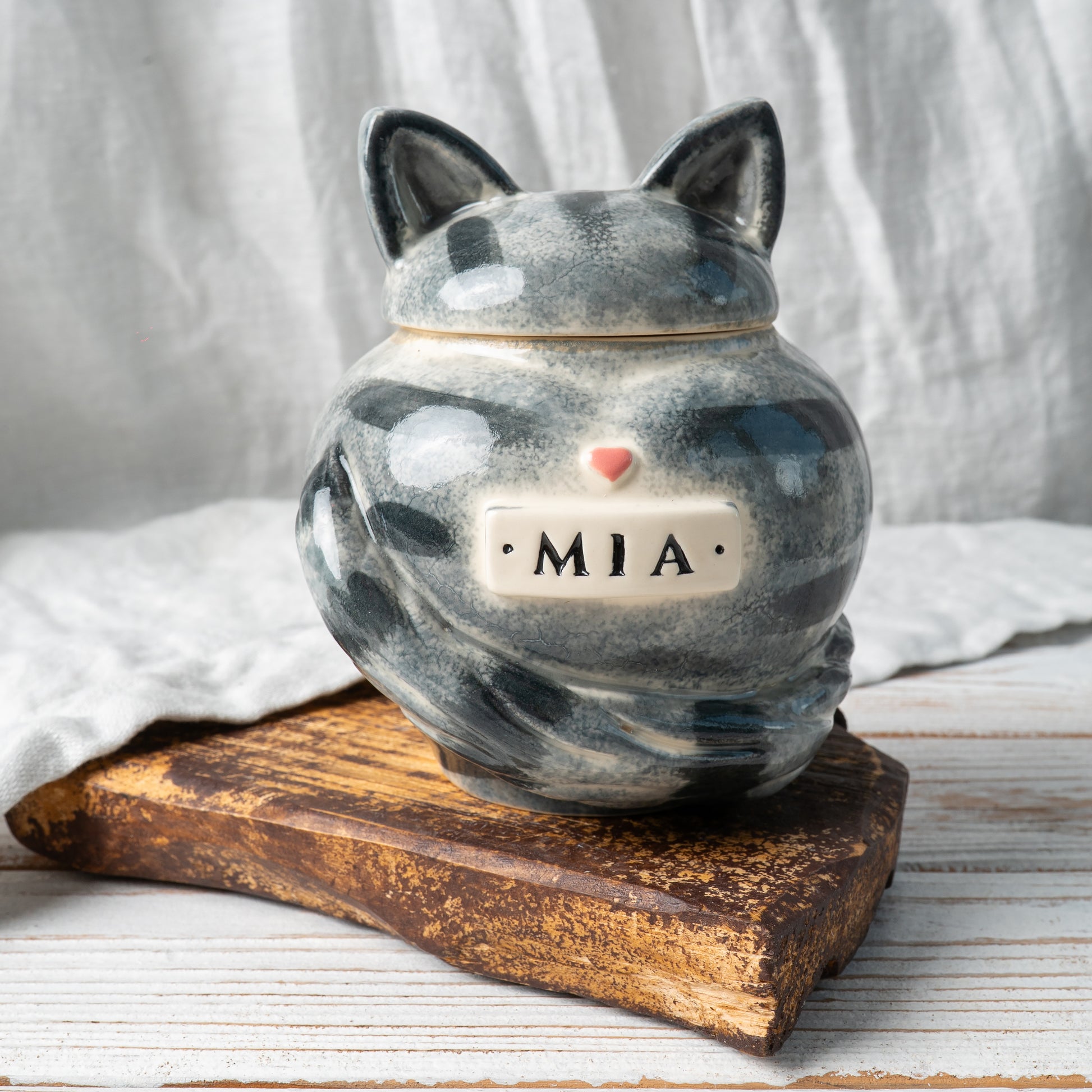 Gray tabby stripes cat heart-shaped ceramic urn for ashes with sculpted cat ears and tail front view