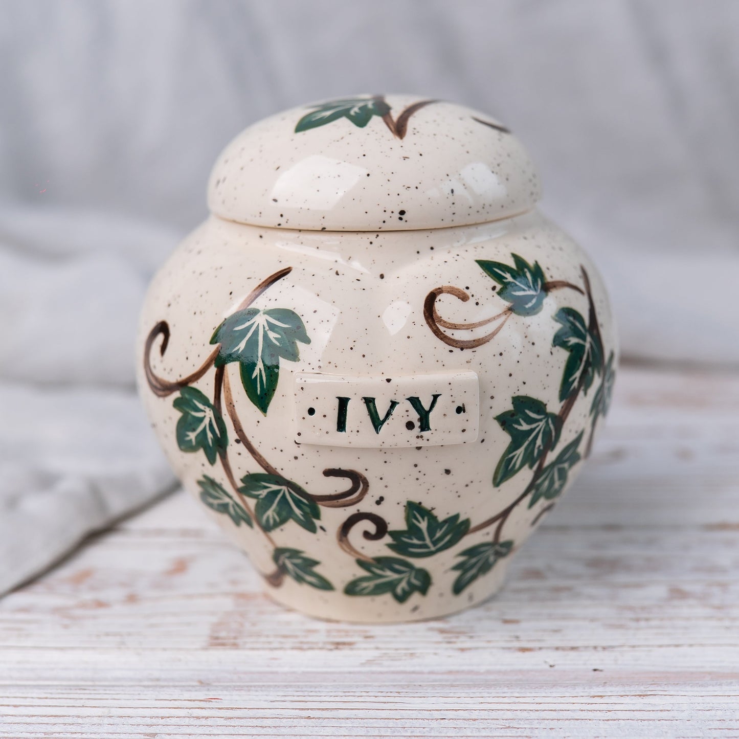 Heart ceramic ivy pet cremation urn for ashes with green ivy vine design front view