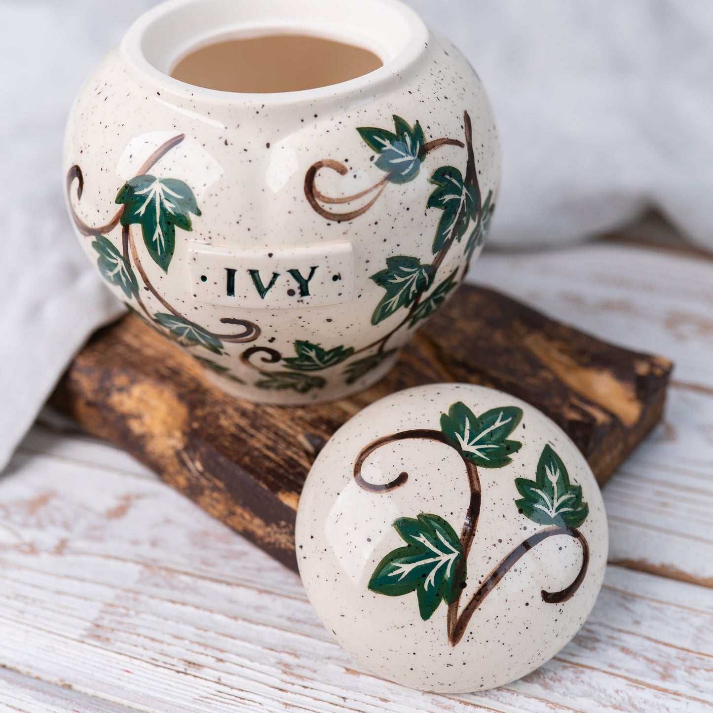 Custom heart ivy pet urn shown open revealing inner chamber for ashes