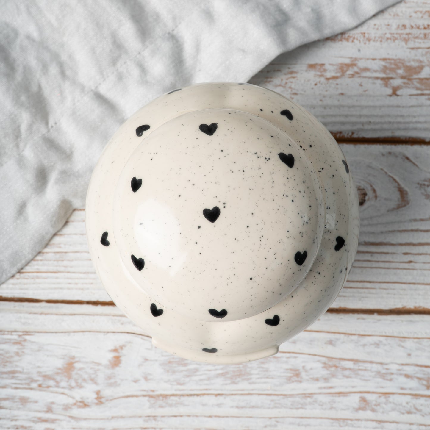 Top-down view of hand-painted ceramic lid for heart-shaped memorial keepsake urn