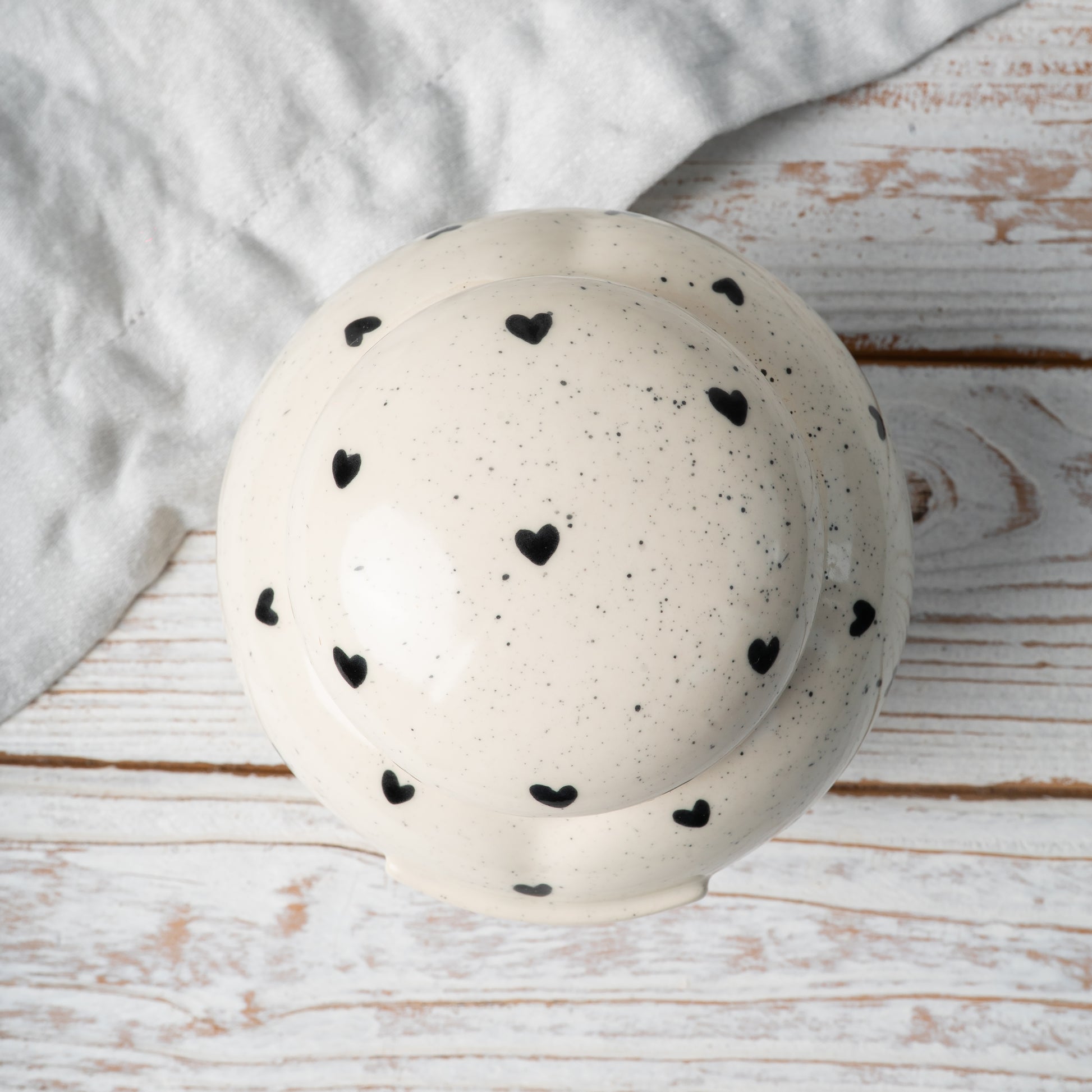 Top-down view of hand-painted ceramic lid for heart-shaped memorial keepsake urn