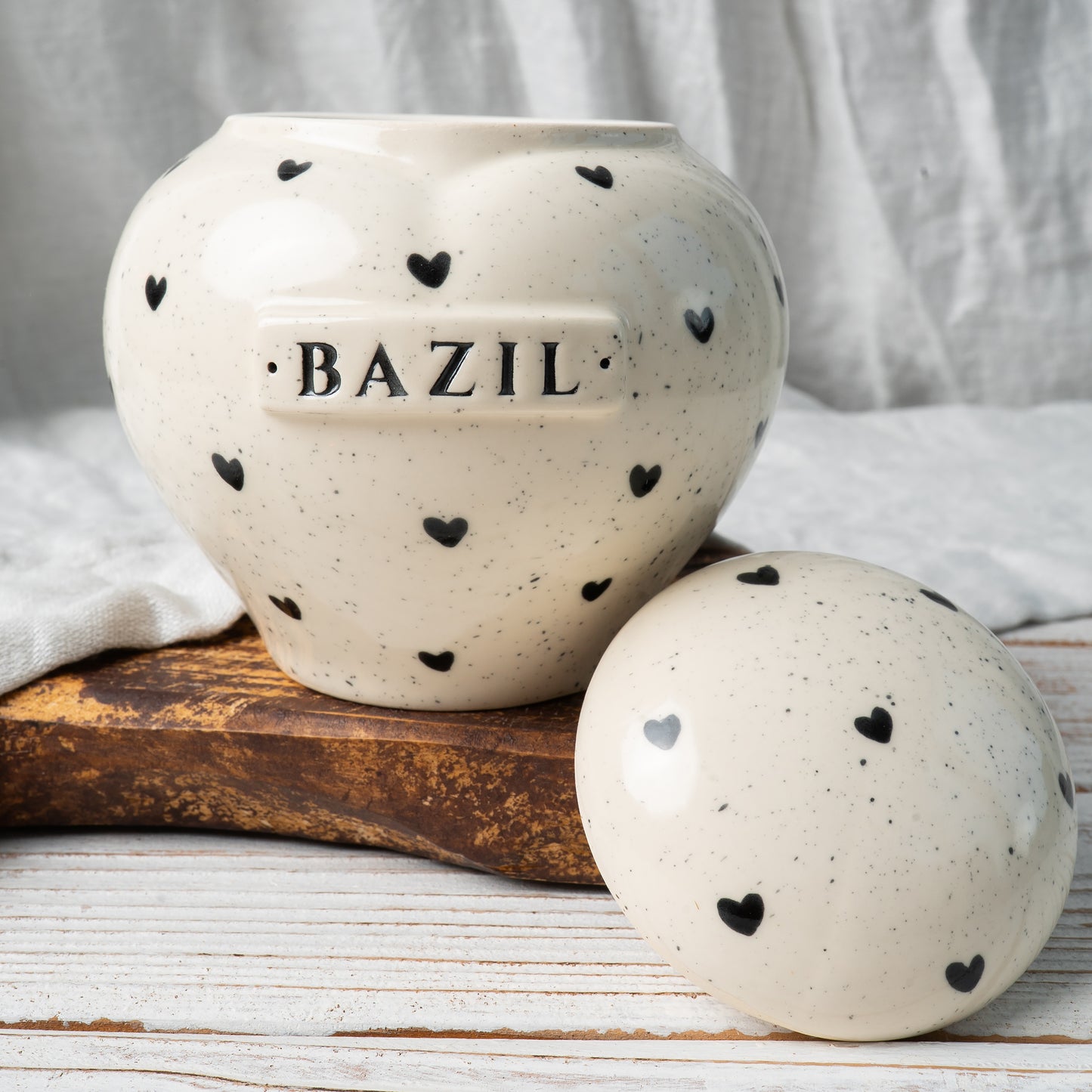 Custom heart print ceramic memorial urn shown open revealing inner chamber for ashes