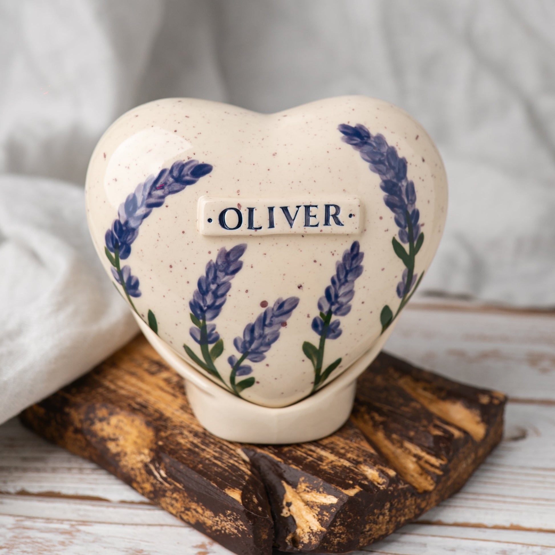 Hand-painted heart-shaped ceramic urn with elegant lavender sprigs and a matching stand for human or pet ashes.