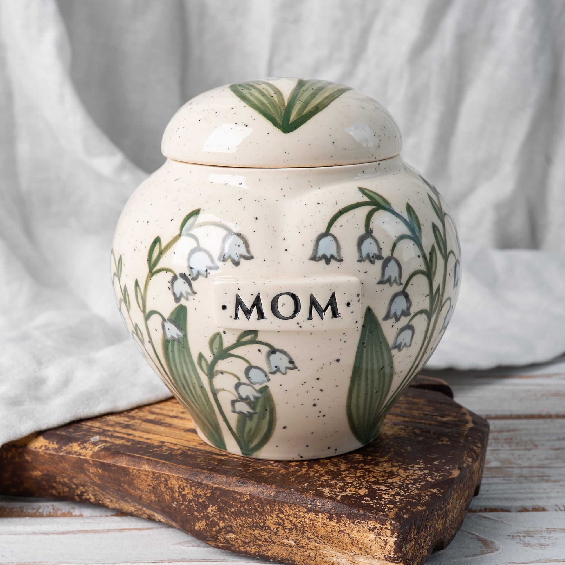Lily of the valley heart-shaped ceramic urn for ashes with delicate hand-painted flowers front view