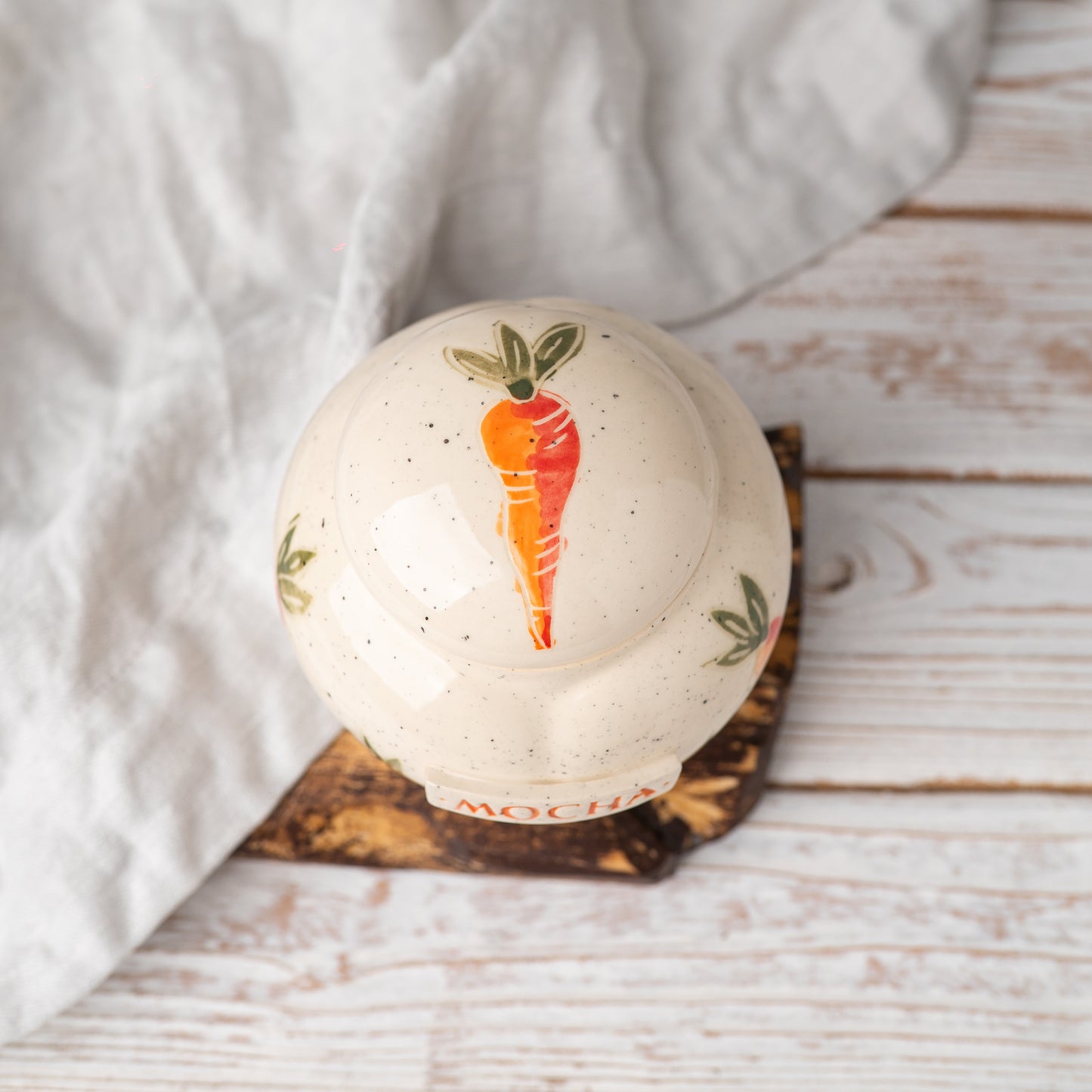 Overhead view of carrot patterned rabbit urn lid