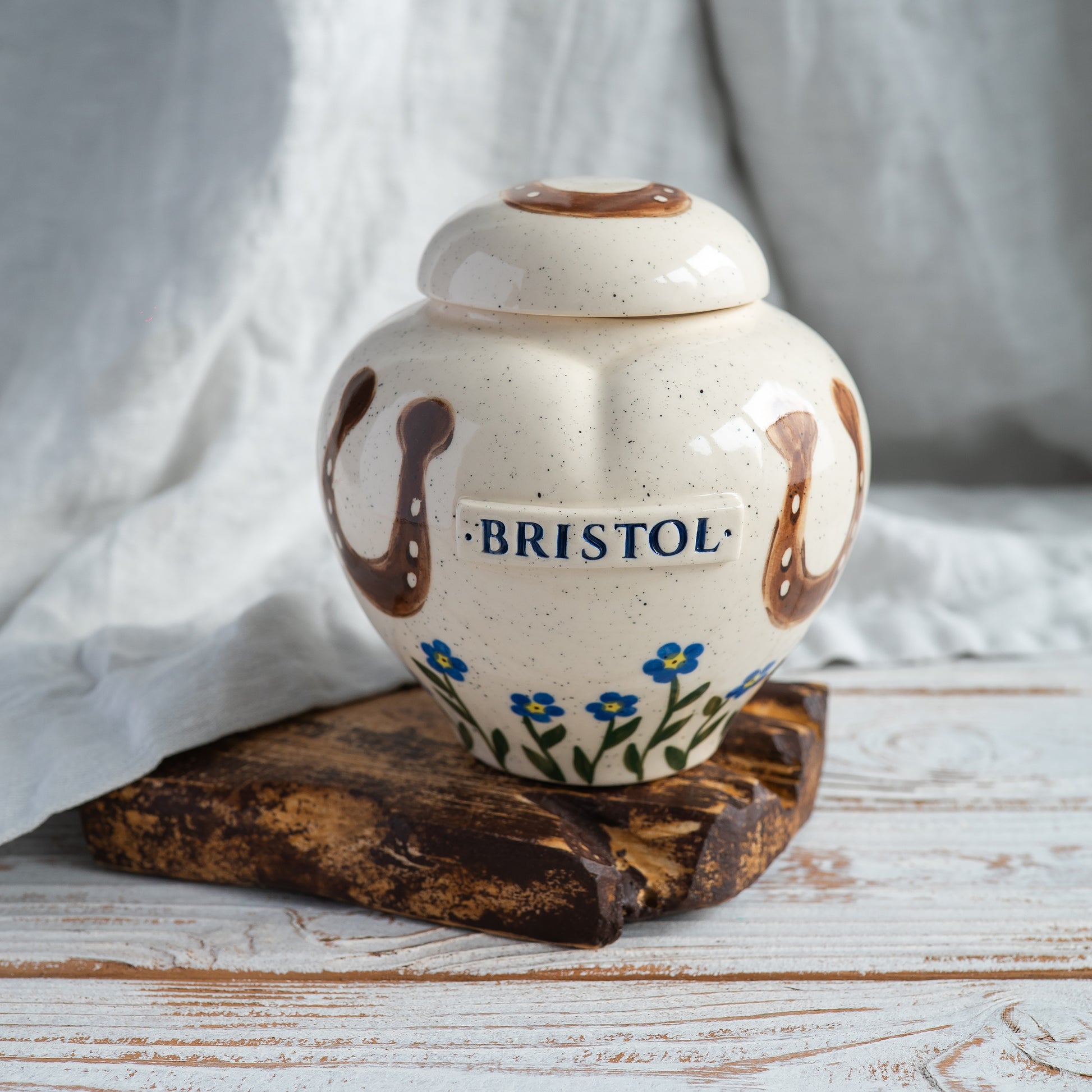front view of a personalized heart-shaped horse urn showing the hand painted details