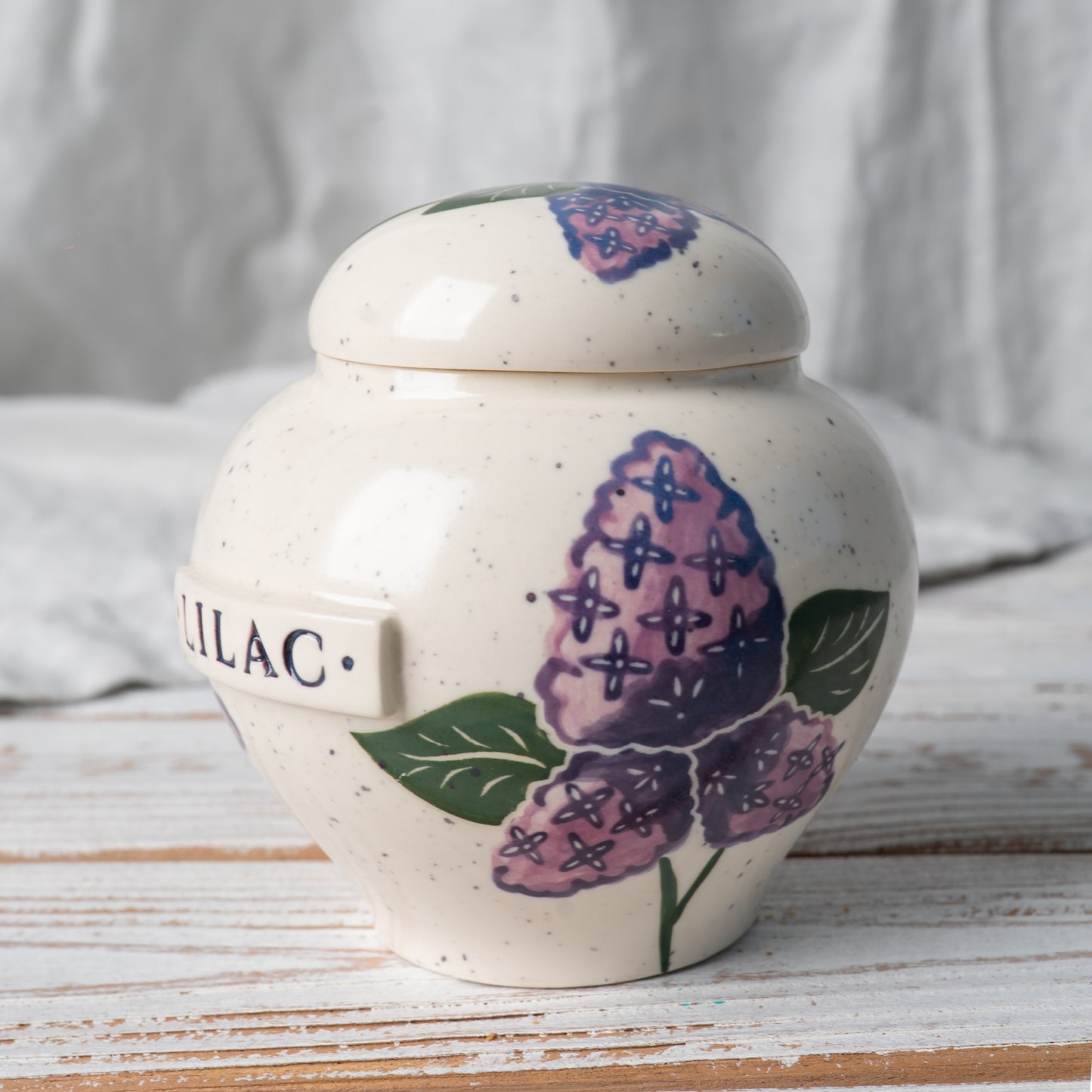Side view of lilac ceramic urn.