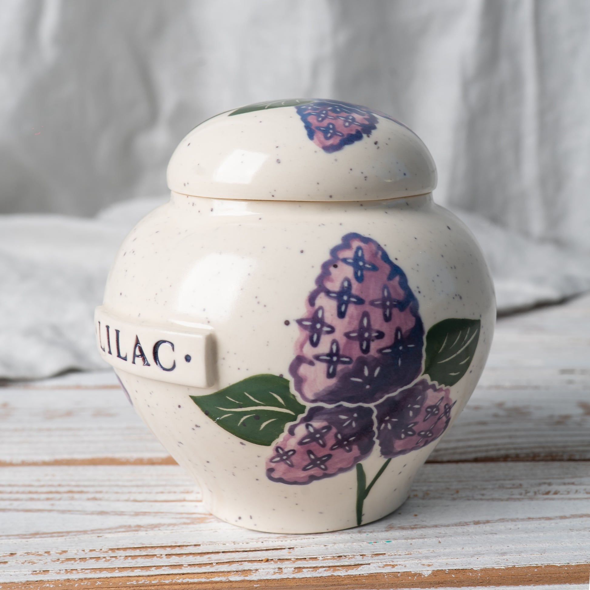 Side view of lilac ceramic urn.
