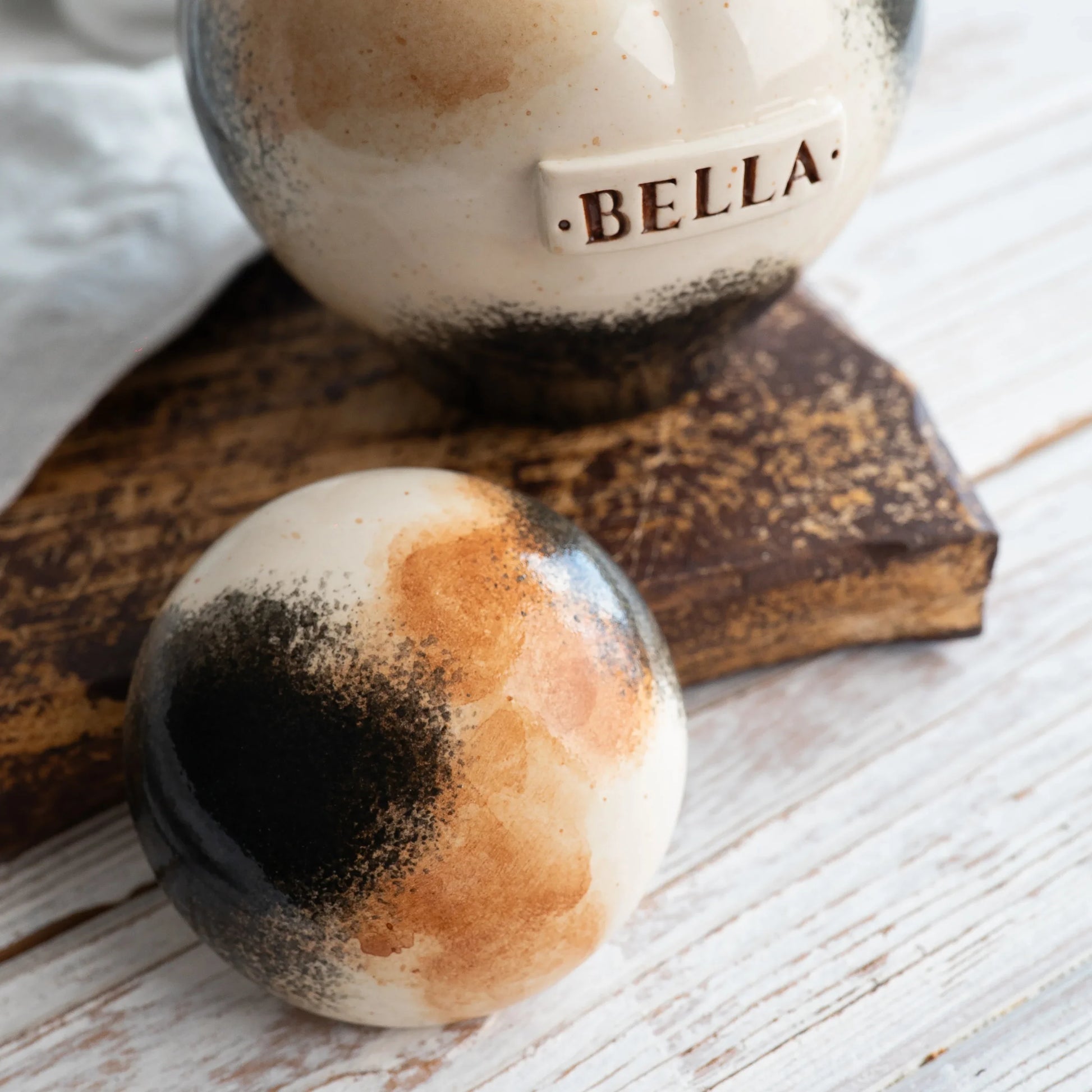 Close-up of open Calico tri-color ceramic heart cat urn by Mira Ceramics.