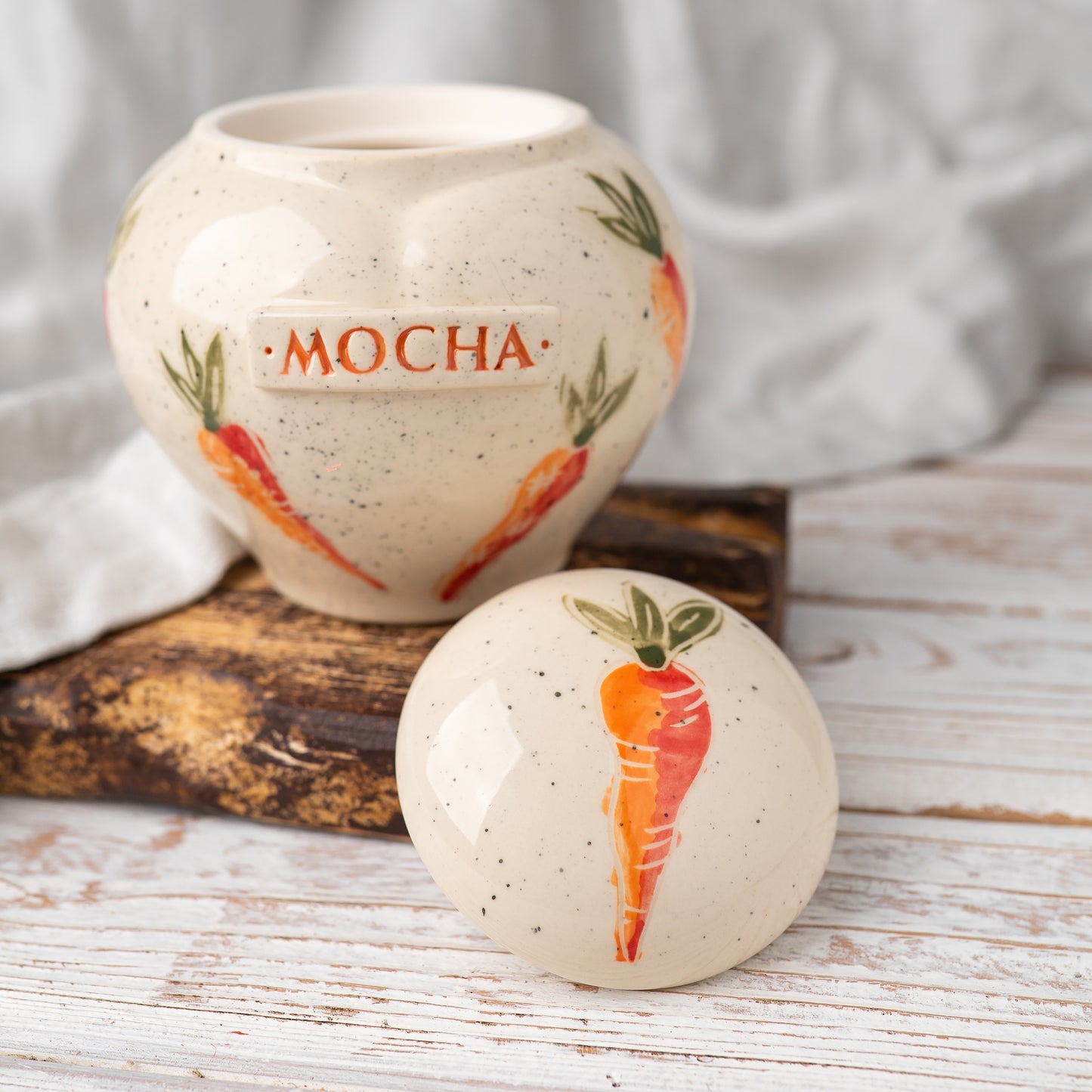 Close-up of open carrot ceramic heart rabbit urn
