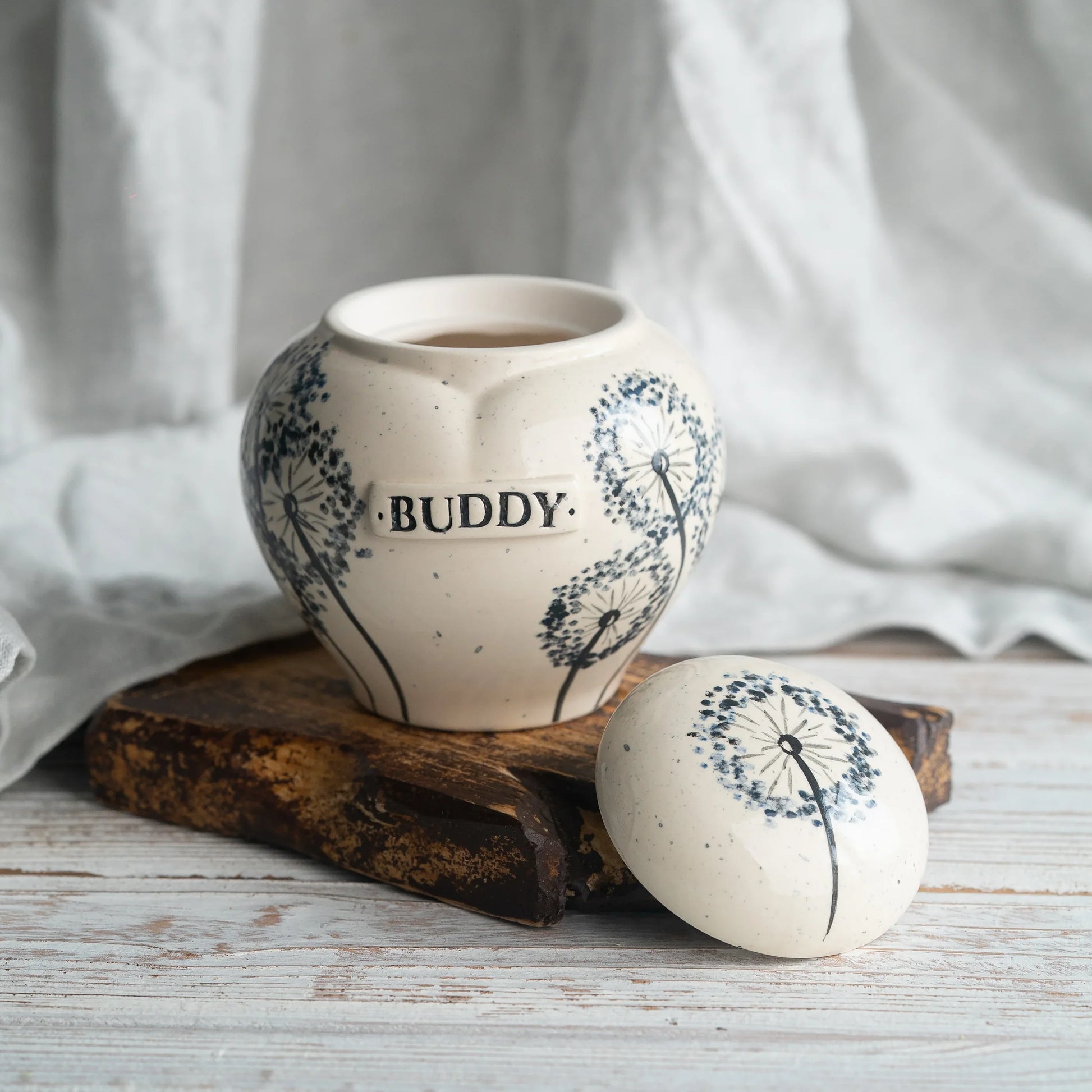 Close-up of open dandelion ceramic heart urn