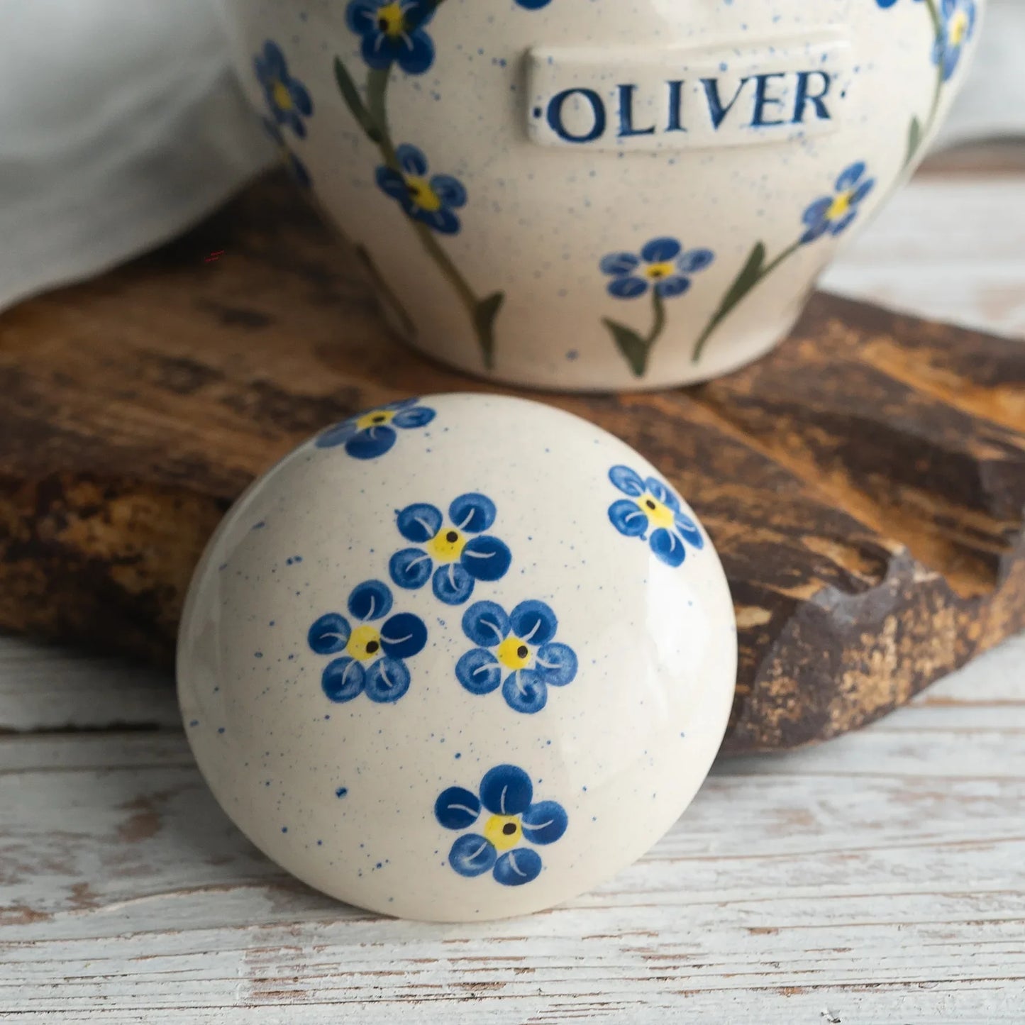 Close-up of open forget-me-nots ceramic heart urn detail by Mira Ceramics.