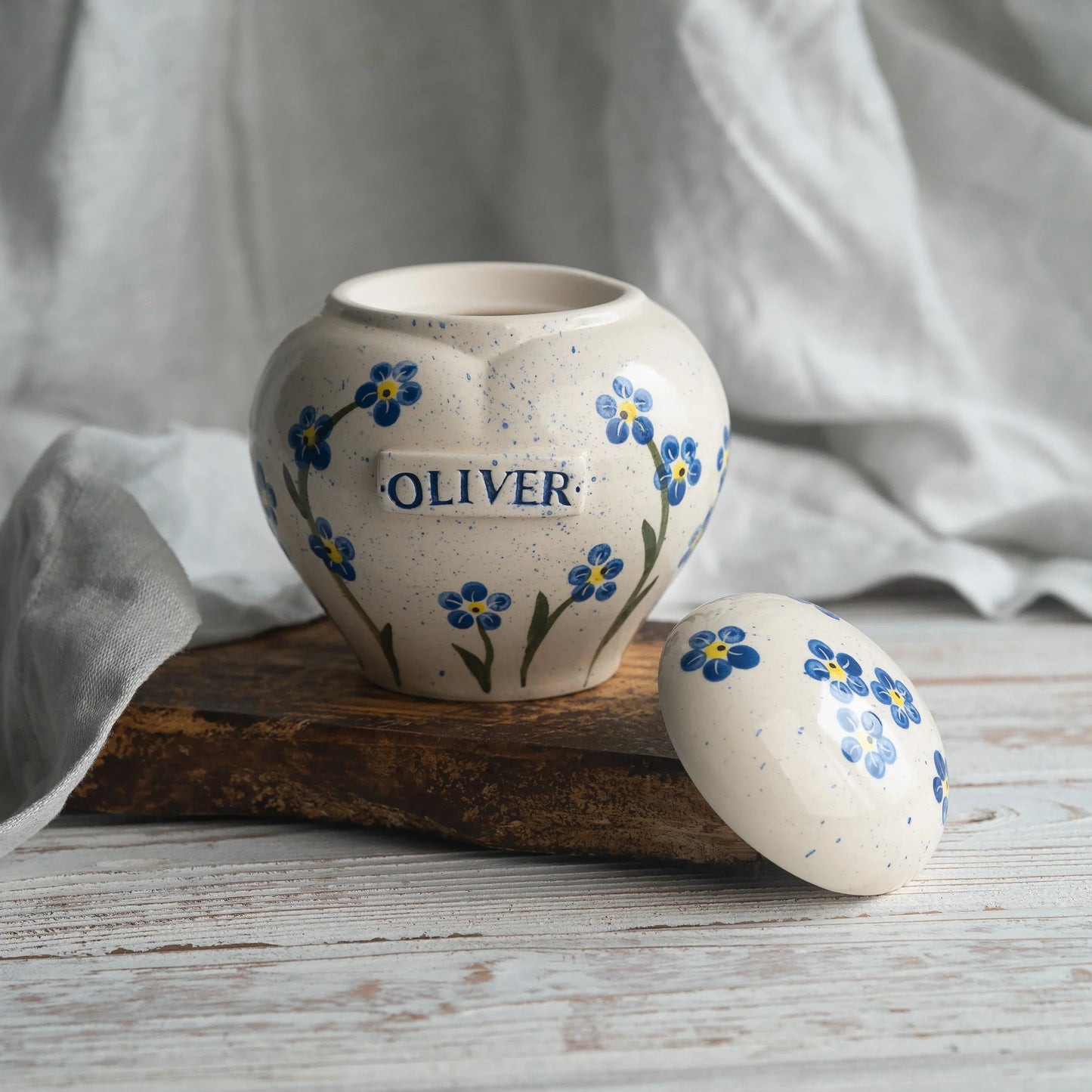 Close-up of open forget-me-nots ceramic heart urn