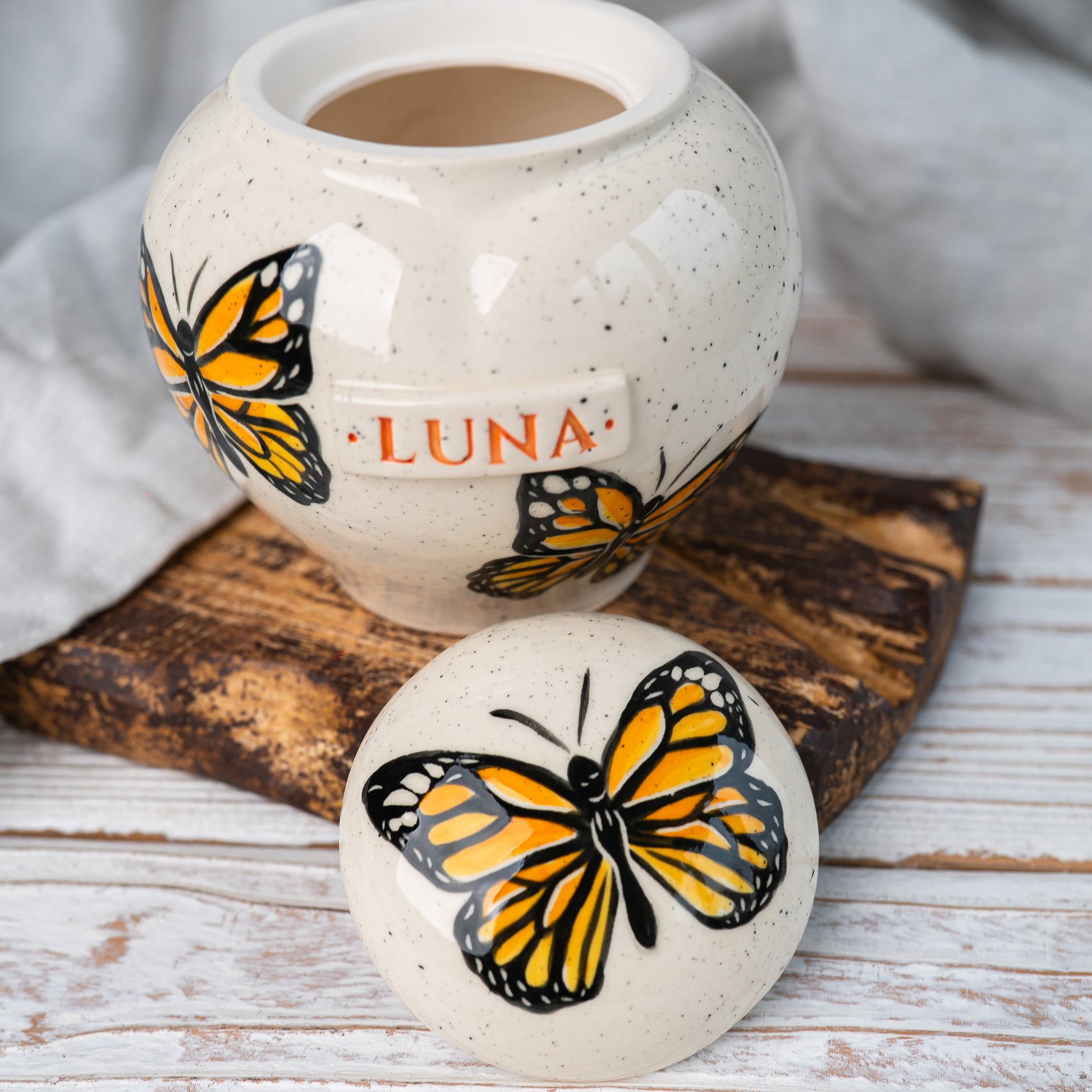 Close-up of open Monarch butterfly ceramic heart urn