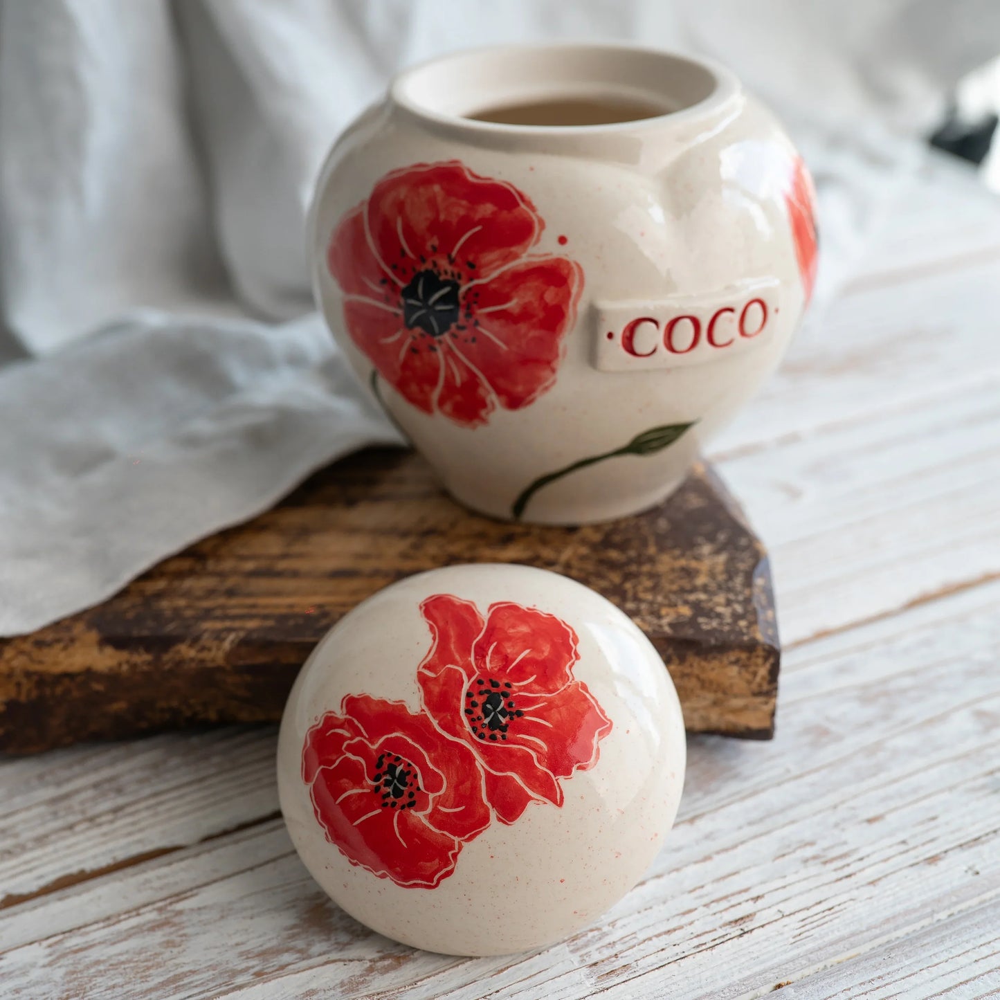 Close-up of open poppy ceramic heart urn detail