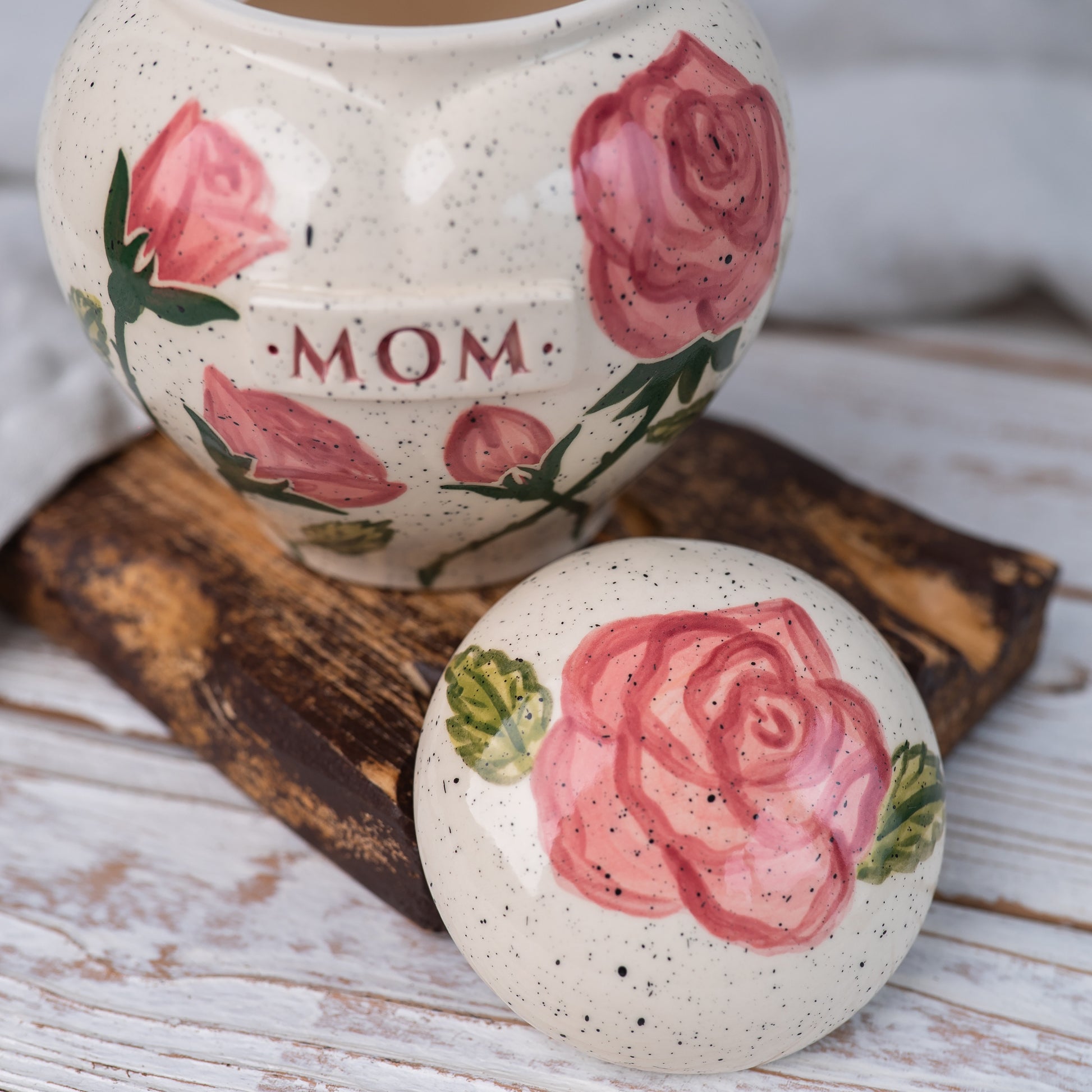 Close-up of open pink rose ceramic heart urn lid