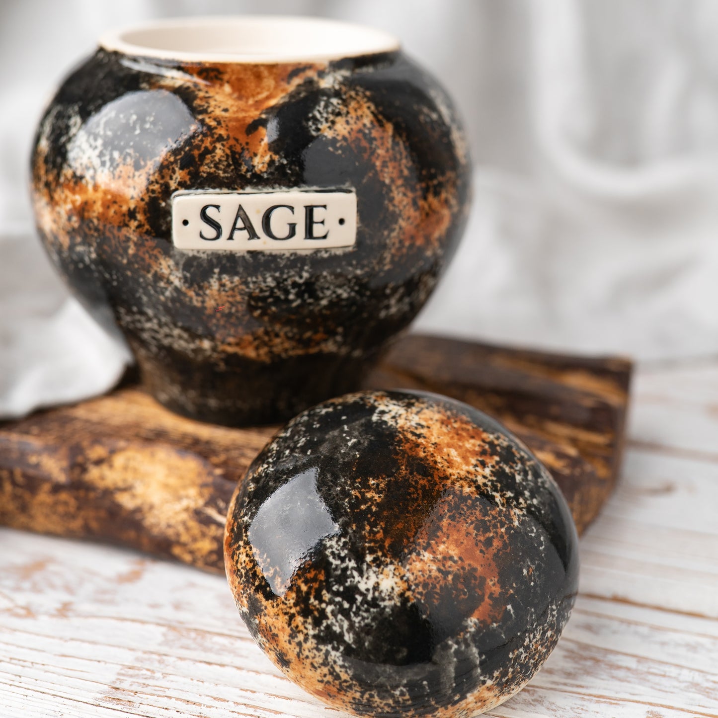 Close-up of open tortoiseshell ceramic heart cat urn