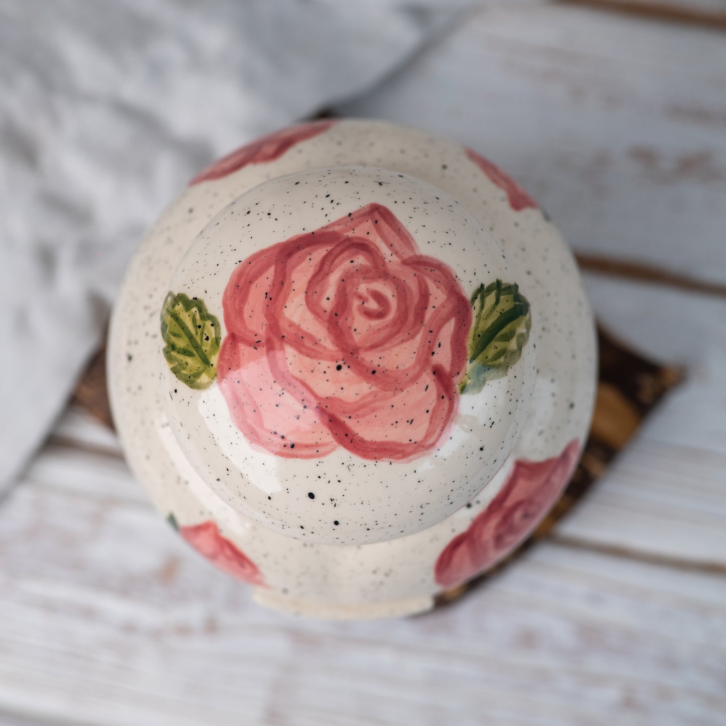Overhead view of pink rose ceramic urn lid