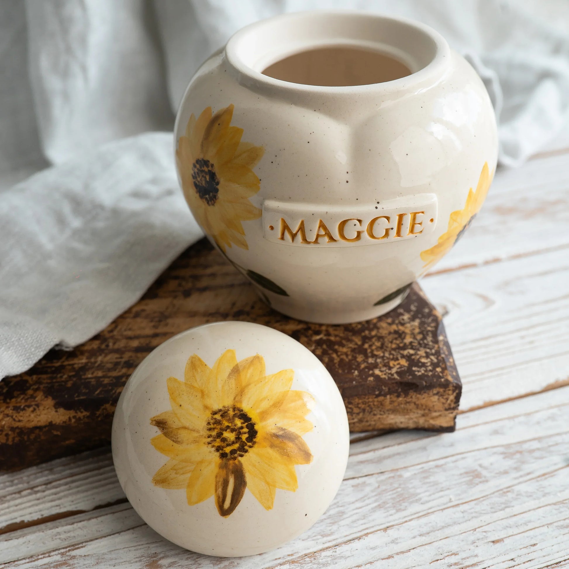 Close-up of open sunflower ceramic heart urn by Mira Ceramics