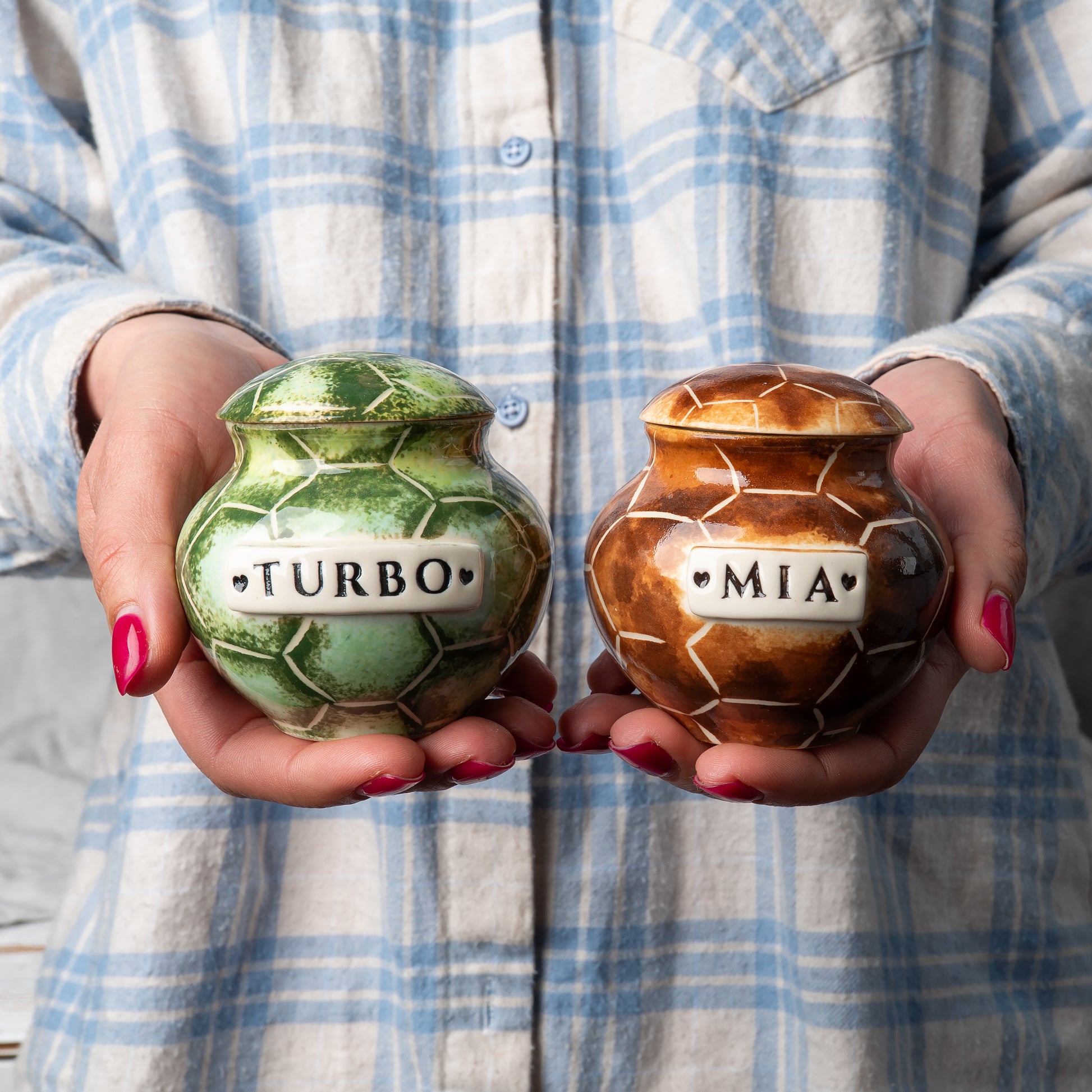 mini custom ceramic turtle pet keepsake urn held gently in hands for scale