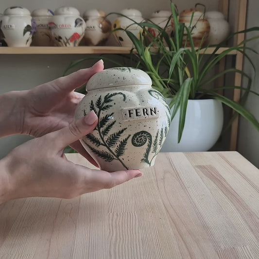 video showcase of the hand-painted fern ceramic heart urn by Mira Ceramics. Displays the intricate green leaf art.