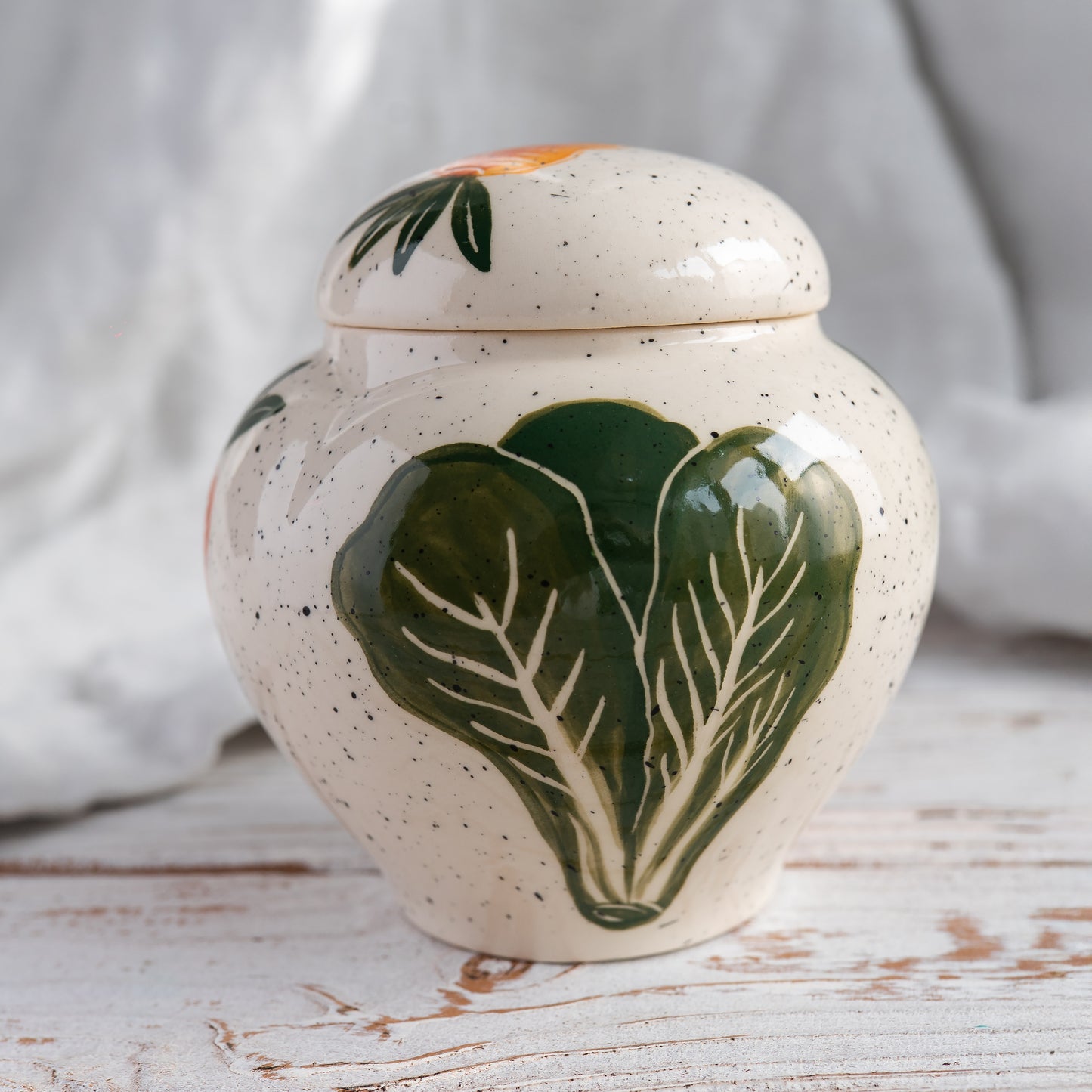 Side view of the heart-shaped memorial vessel showing the hand-painted  cabbage