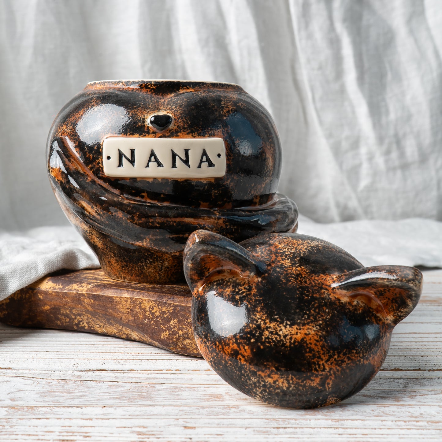 Custom tortoiseshell cat ceramic urn with cat ears shown open revealing inner chamber for ashes