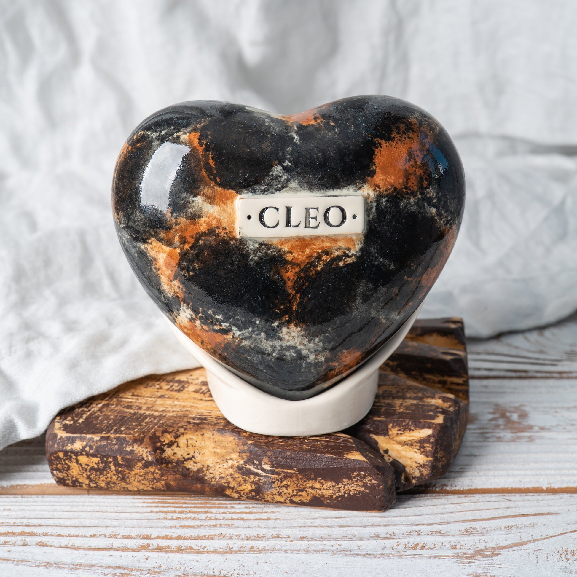 Hand-painted tortoiseshell cat heart-shaped ceramic memorial urn with floral motifs, front view by Mira Ceramic