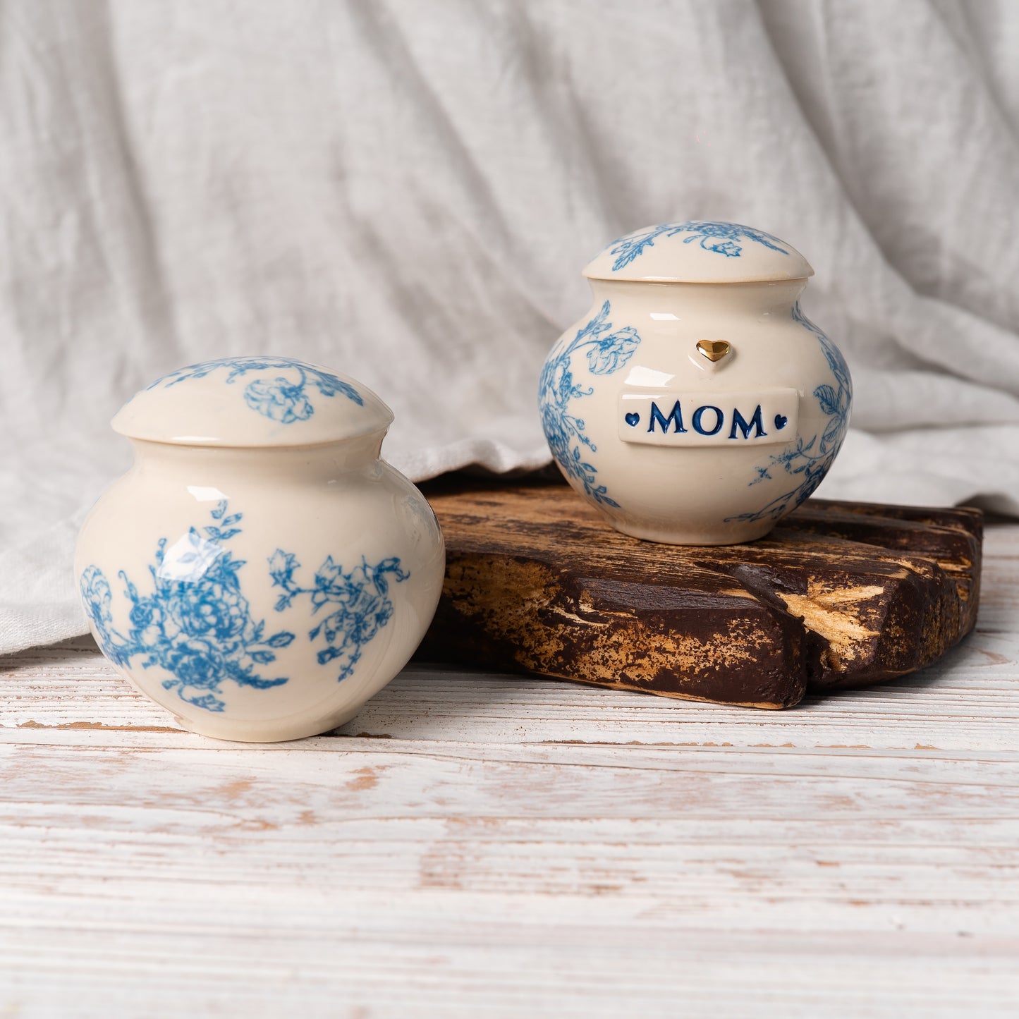 two mini urns with blue and white floral toile design